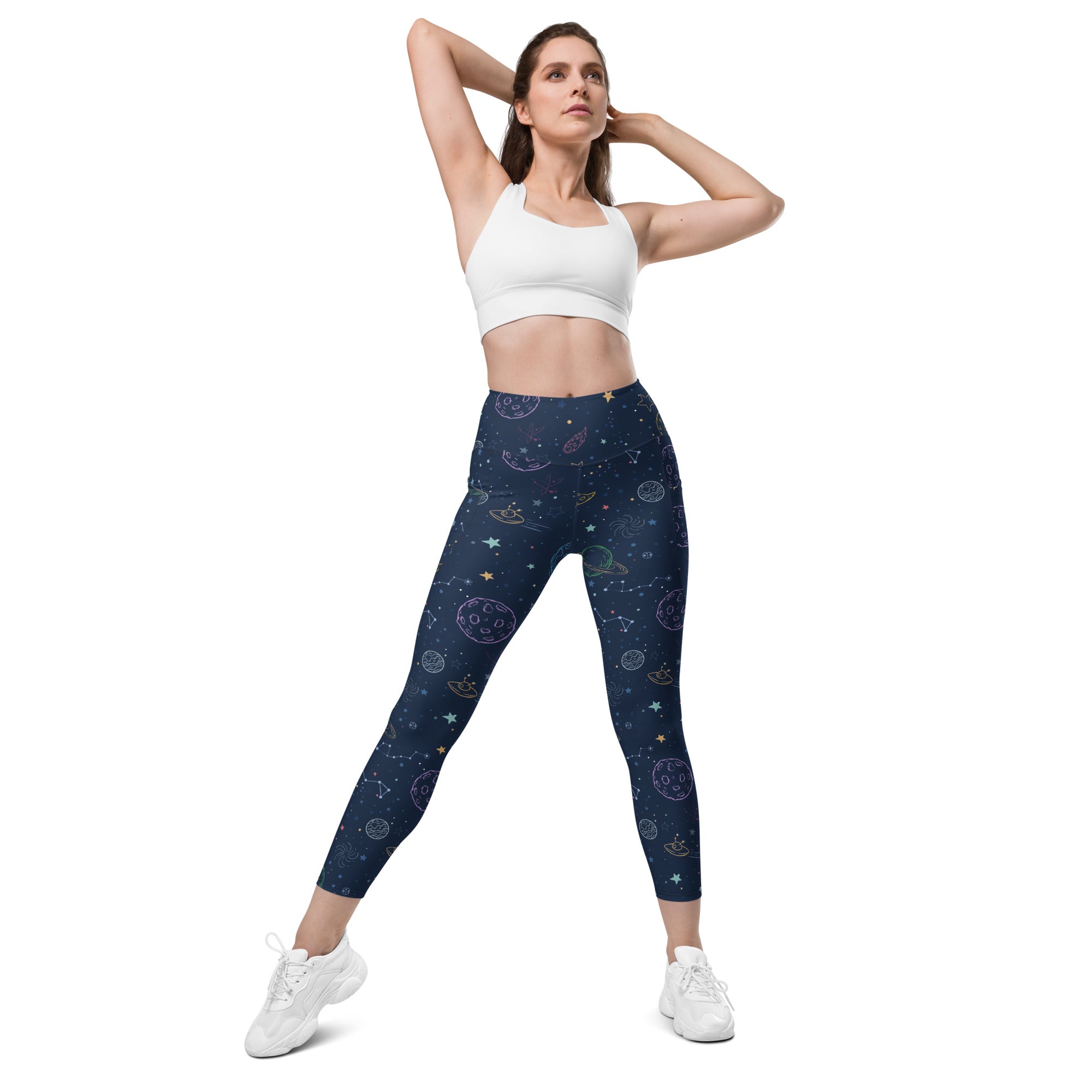 Women’s high-waisted dark blue galaxy space yoga leggings with pockets featuring pastel celestial patterns and soft compression