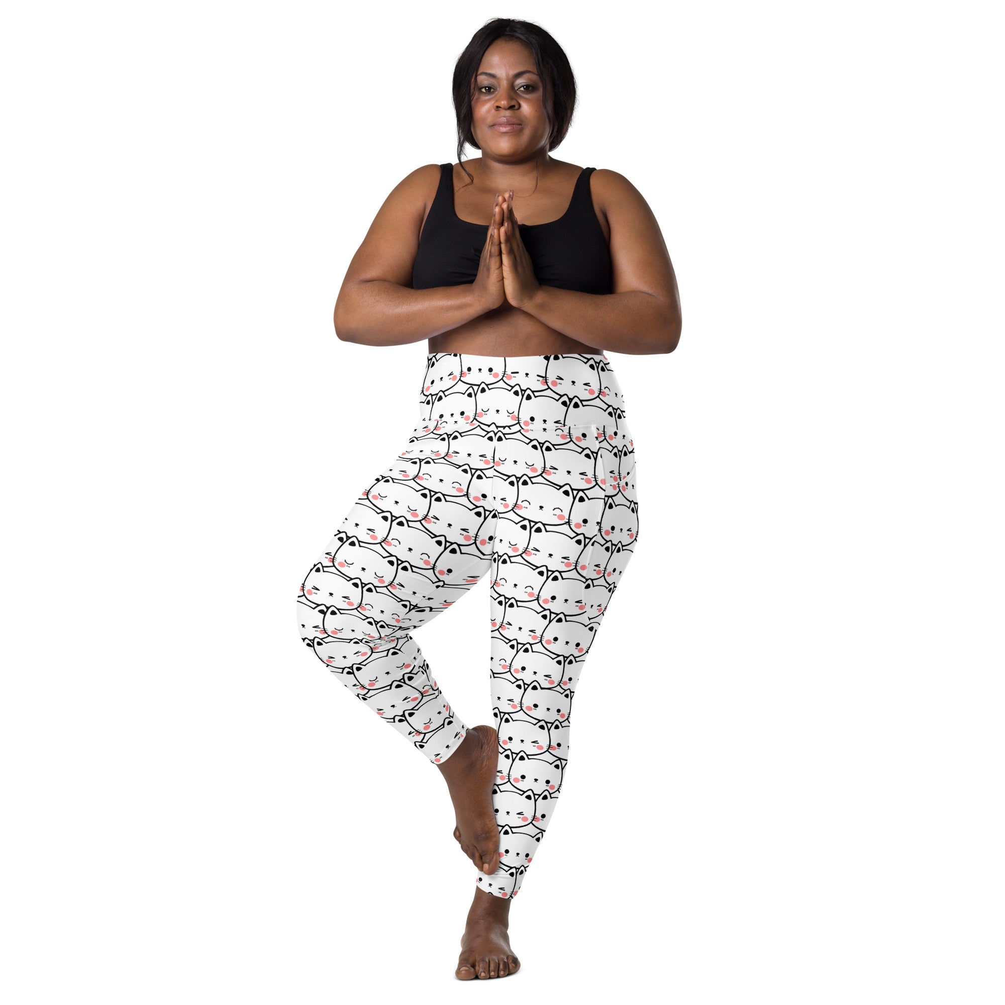 White high waisted yoga leggings with pockets featuring a repeating minimalist kawaii cat face pattern with pink accents