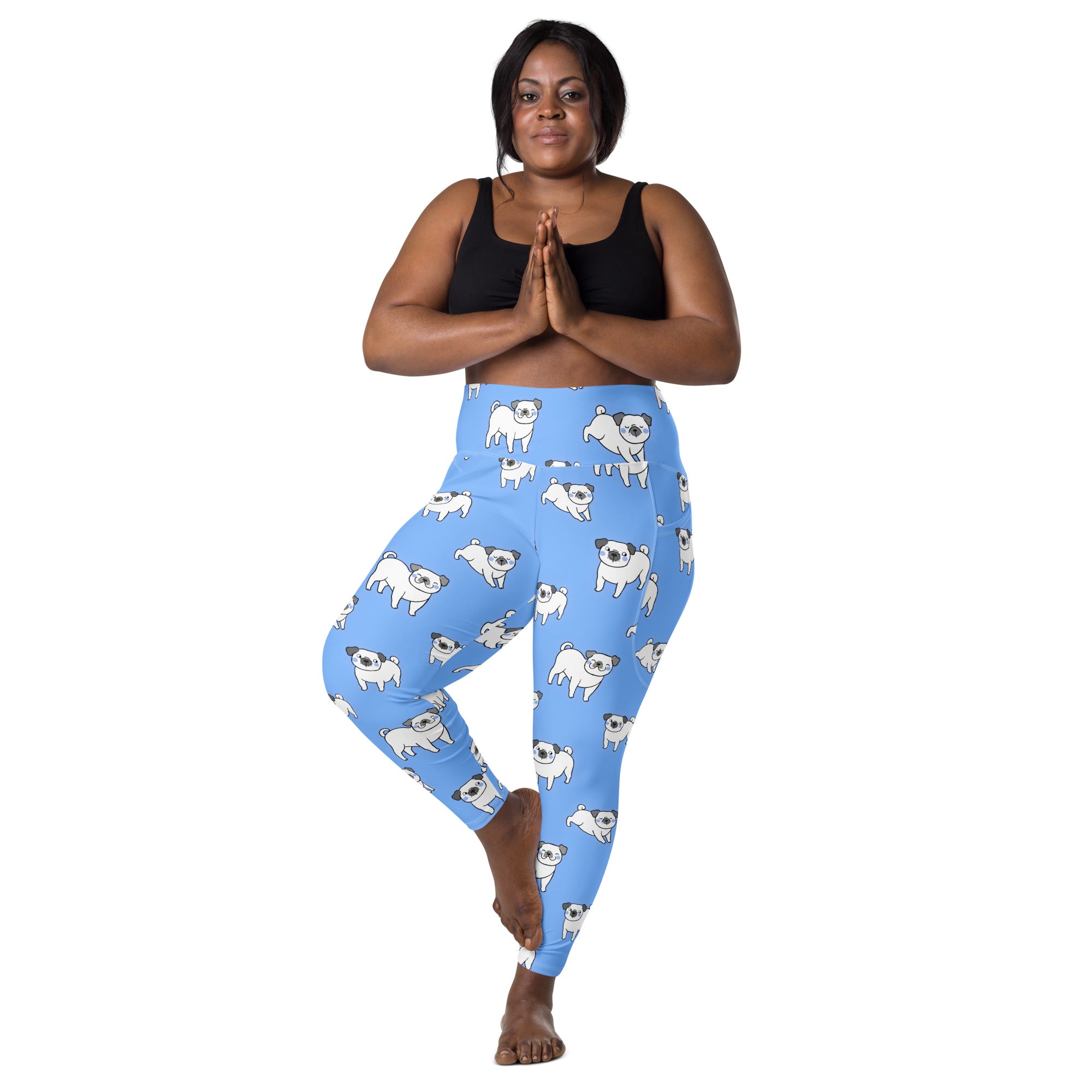 Women’s light blue high-waisted yoga leggings with pockets featuring a playful white pug dog pattern and soft compression