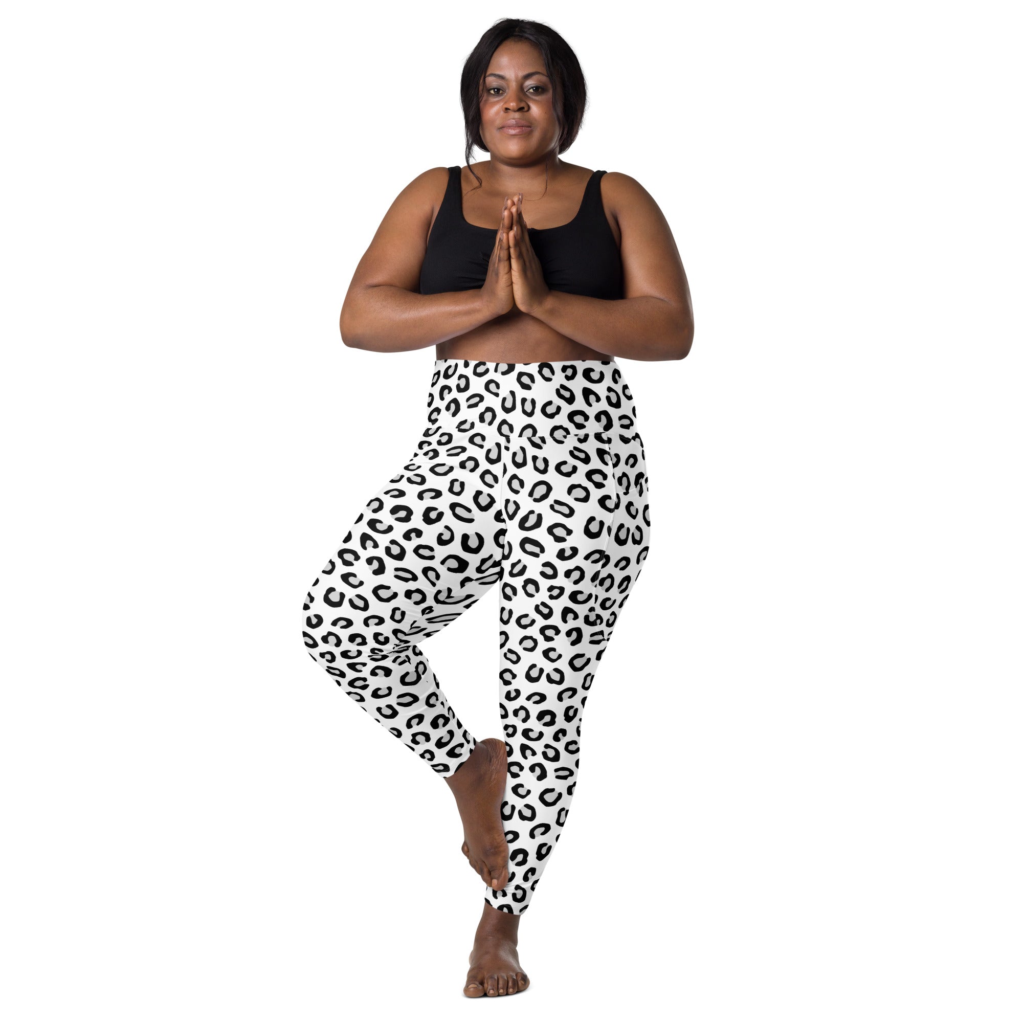 Women’s high-waisted white leggings with bold black leopard print soft compression pockets for yoga and activewear