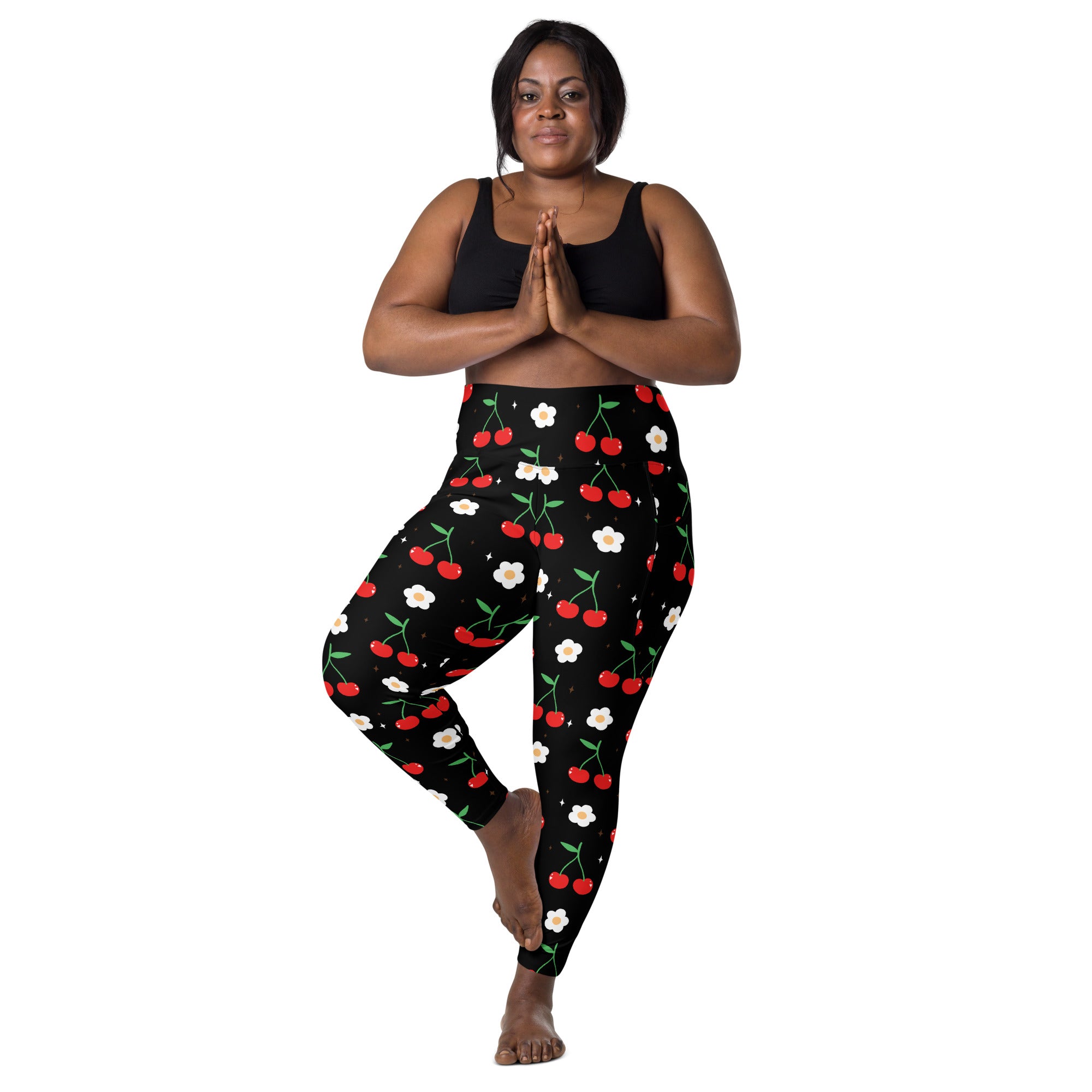 Women’s black high-waisted cherry print yoga leggings with pockets featuring soft compression fabric and floral pattern