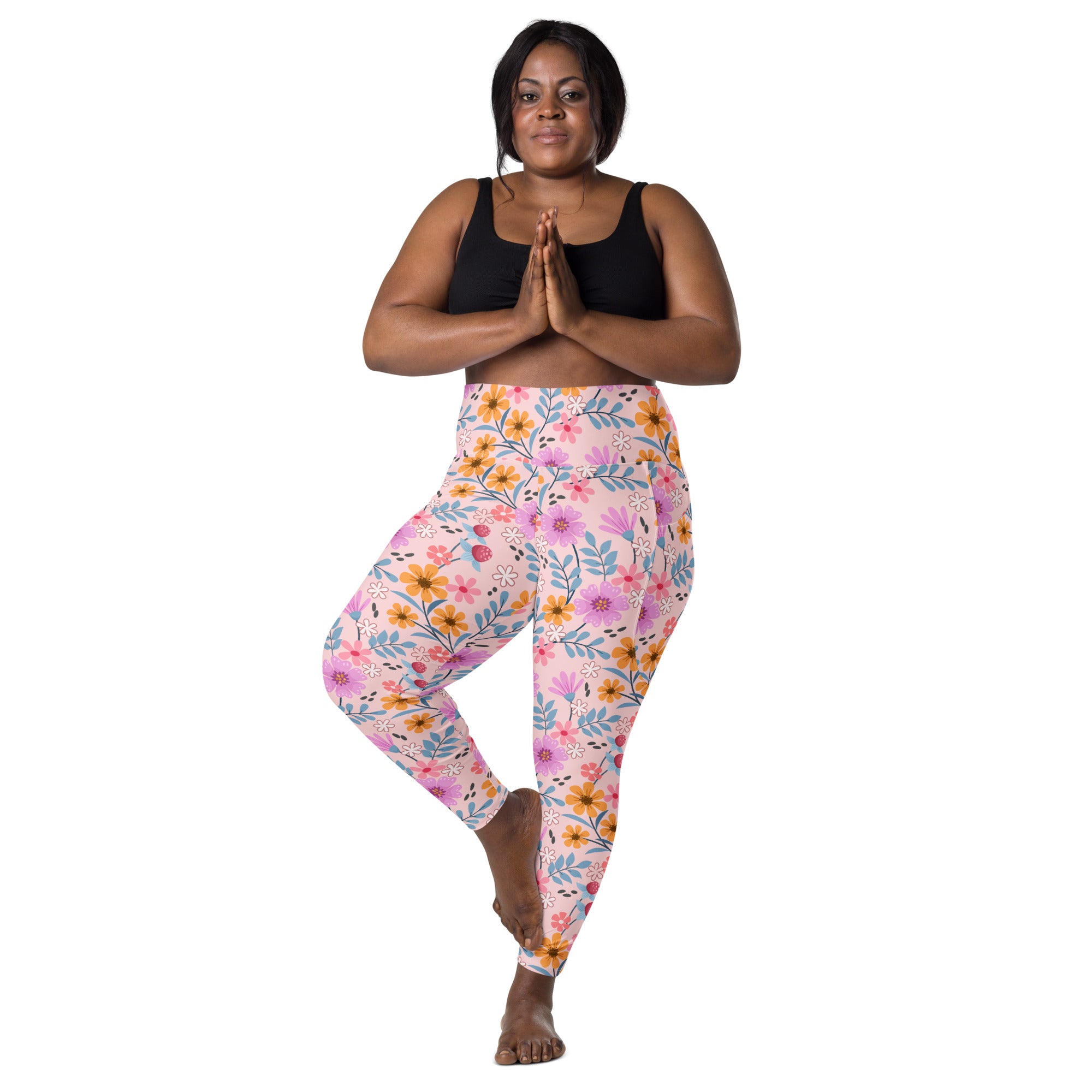 Women’s pink floral high-waisted yoga leggings with soft compression fabric and convenient pockets for active wear