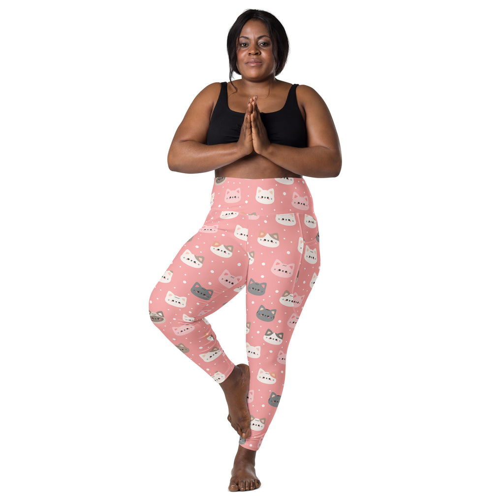 Women’s pink high-waisted yoga leggings with pockets featuring white and gray cartoon cat faces and polka dots
