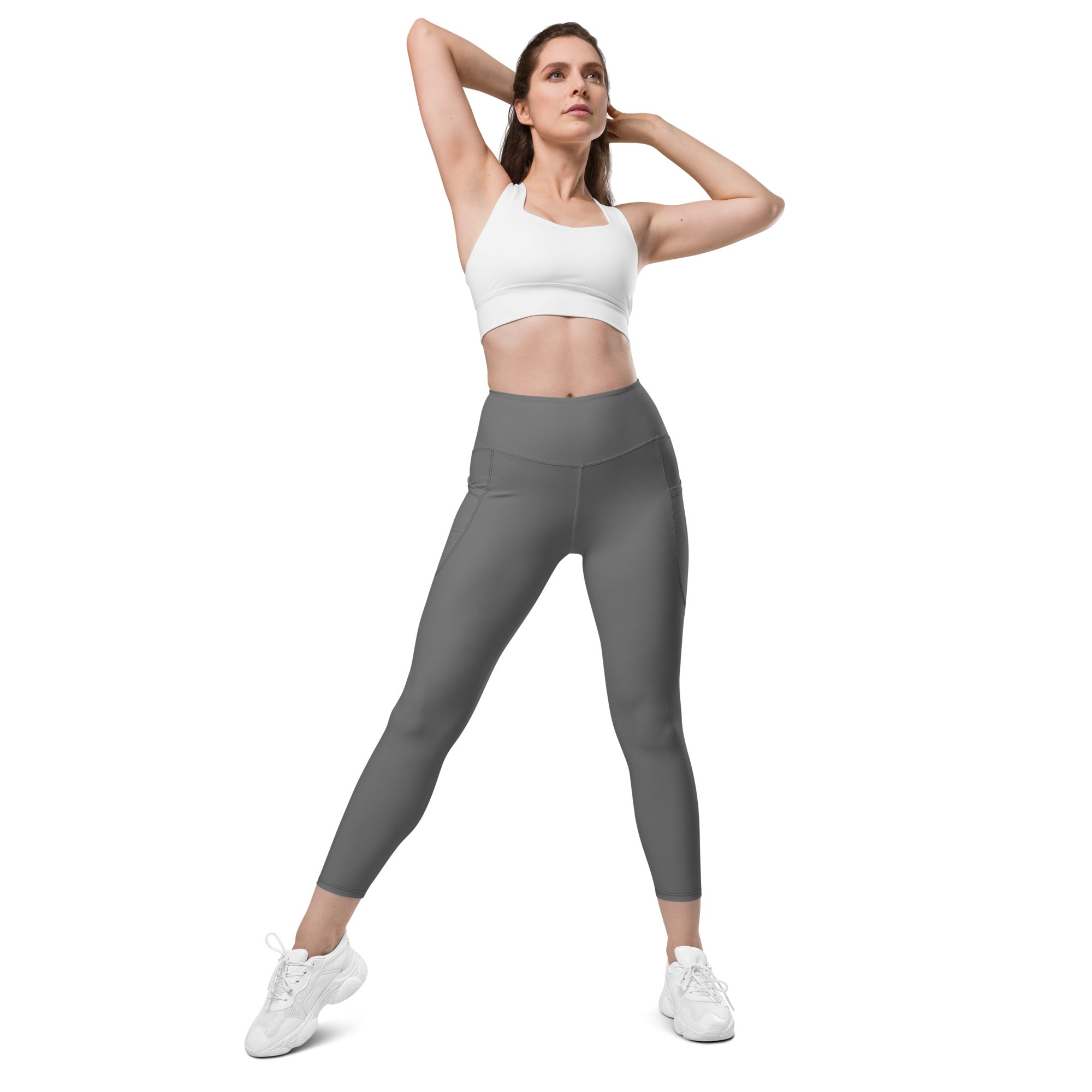 Women’s gray high-waisted yoga leggings with soft compression, smooth stretchy fabric, and subtle side pockets