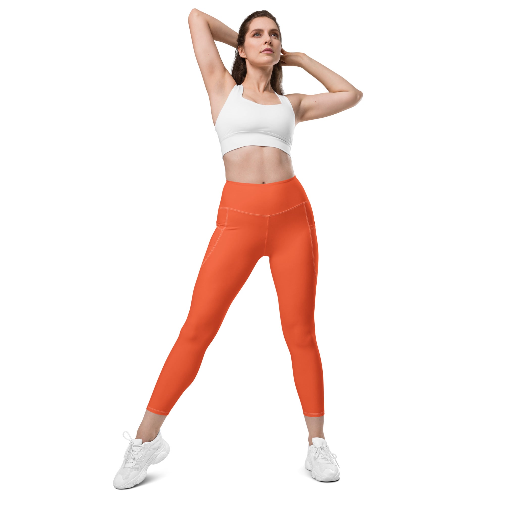 Women’s bright orange high-waisted yoga leggings with soft compression and side pockets for activewear use
