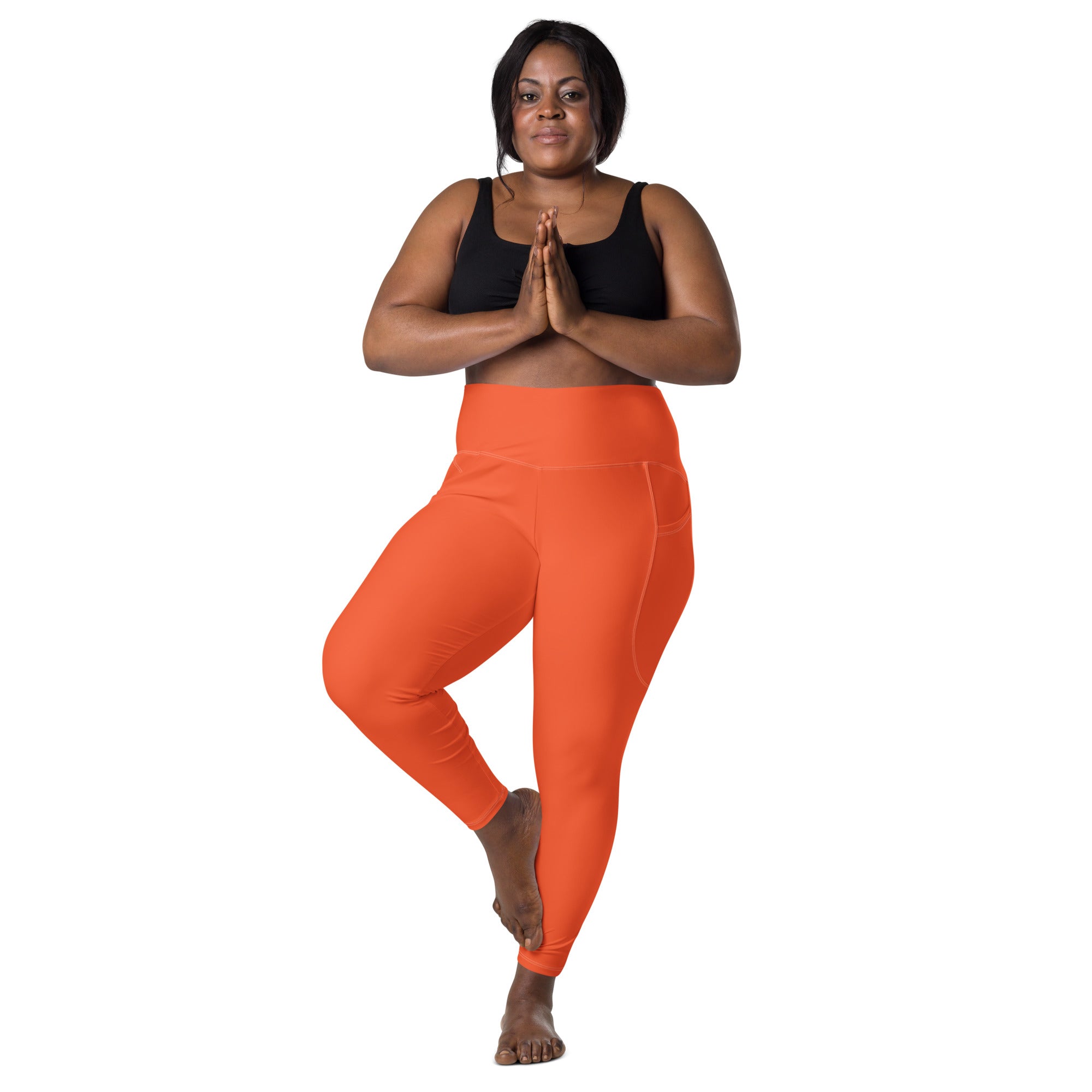 Women’s orange high-waisted yoga leggings with smooth stretchy fabric and side pockets for active wear