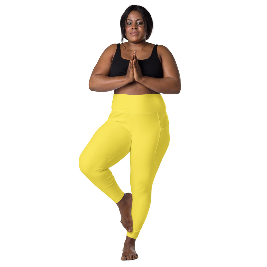 Women’s bright yellow high-waisted yoga leggings with pockets featuring a sleek, soft compression design