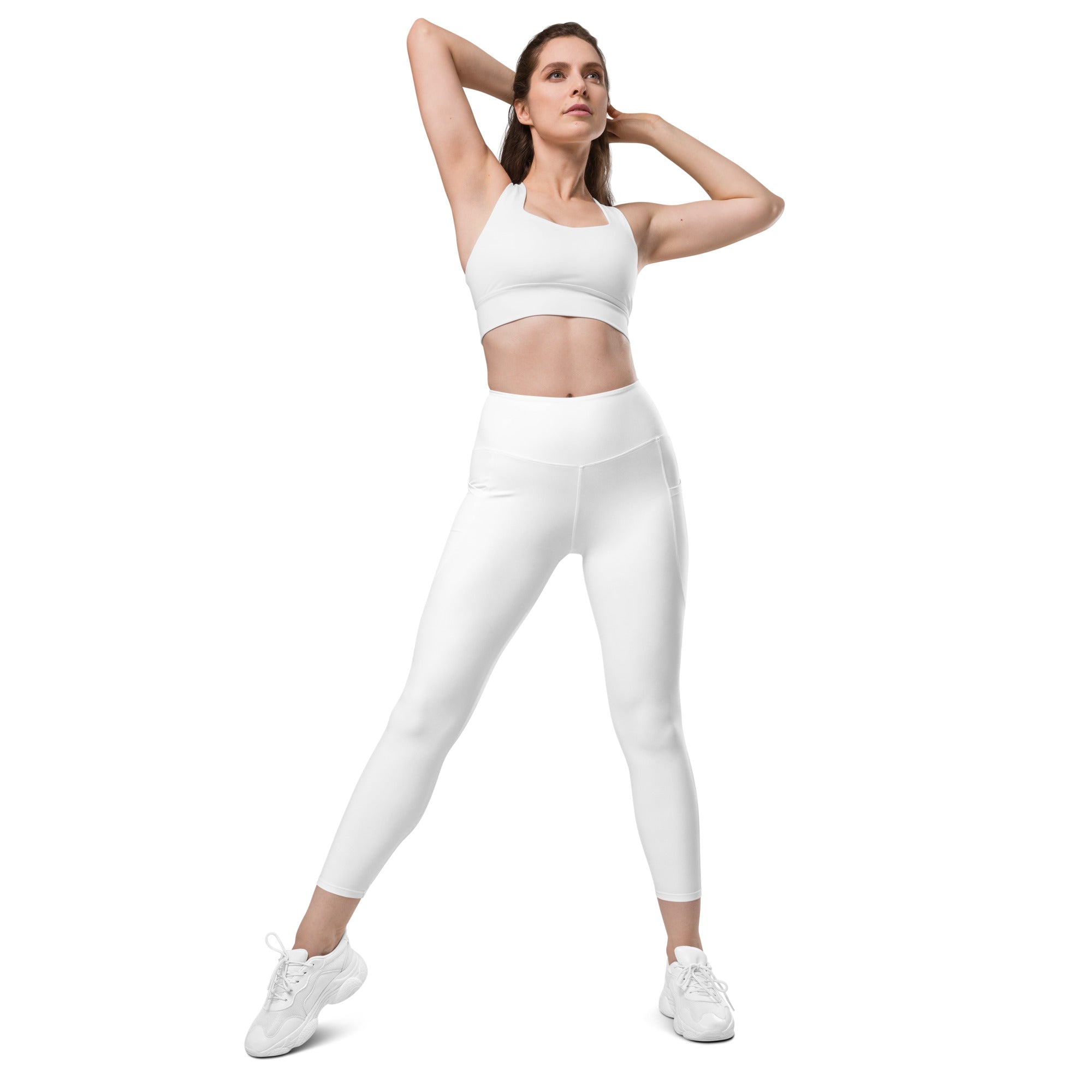 Women’s white high-waisted yoga leggings with pockets made of smooth, form-fitting stretch fabric and soft compression