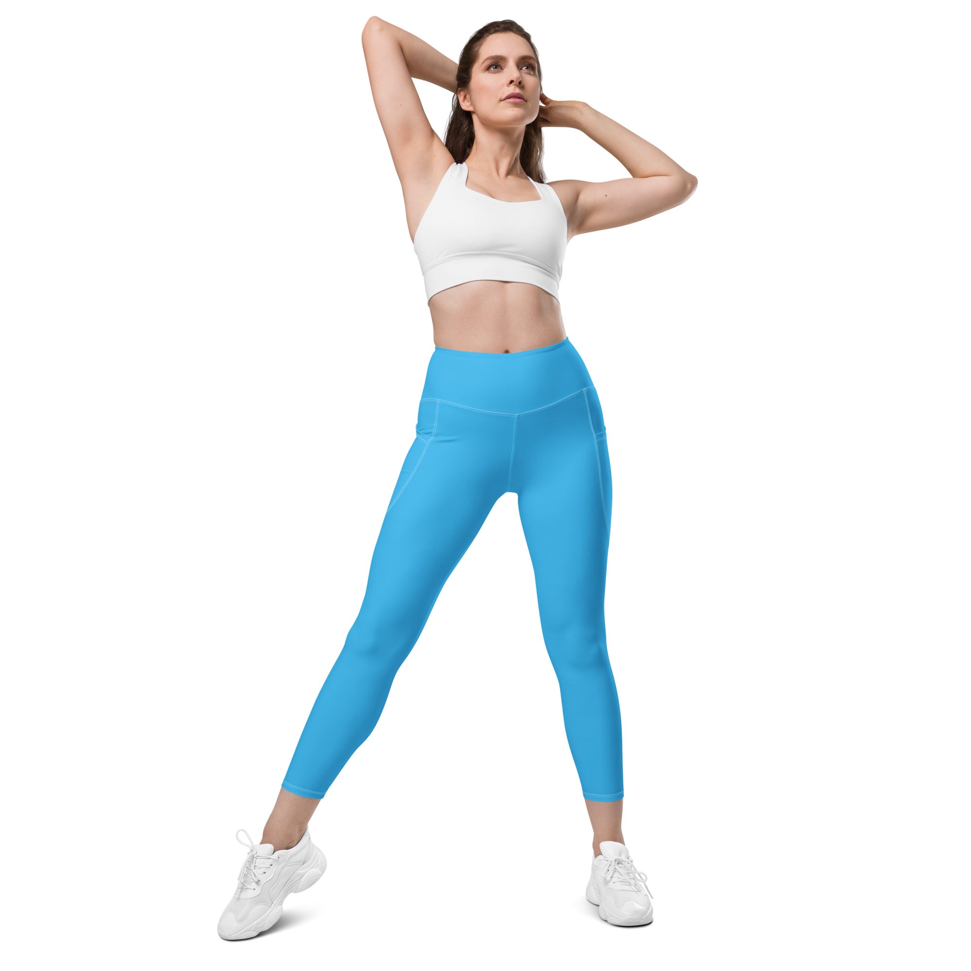 Women’s blue high-waisted yoga leggings with pockets featuring a sleek, form-fitting design and soft compression fabric