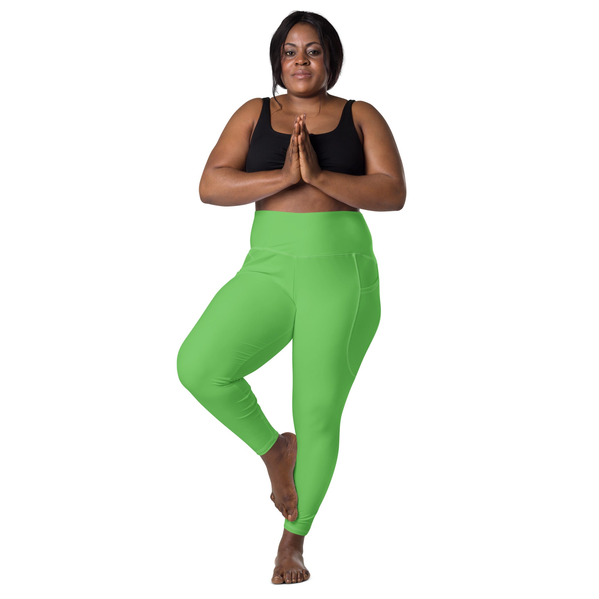 Women’s green high-waisted yoga leggings with soft compression stretchy fabric and side pockets for active wear