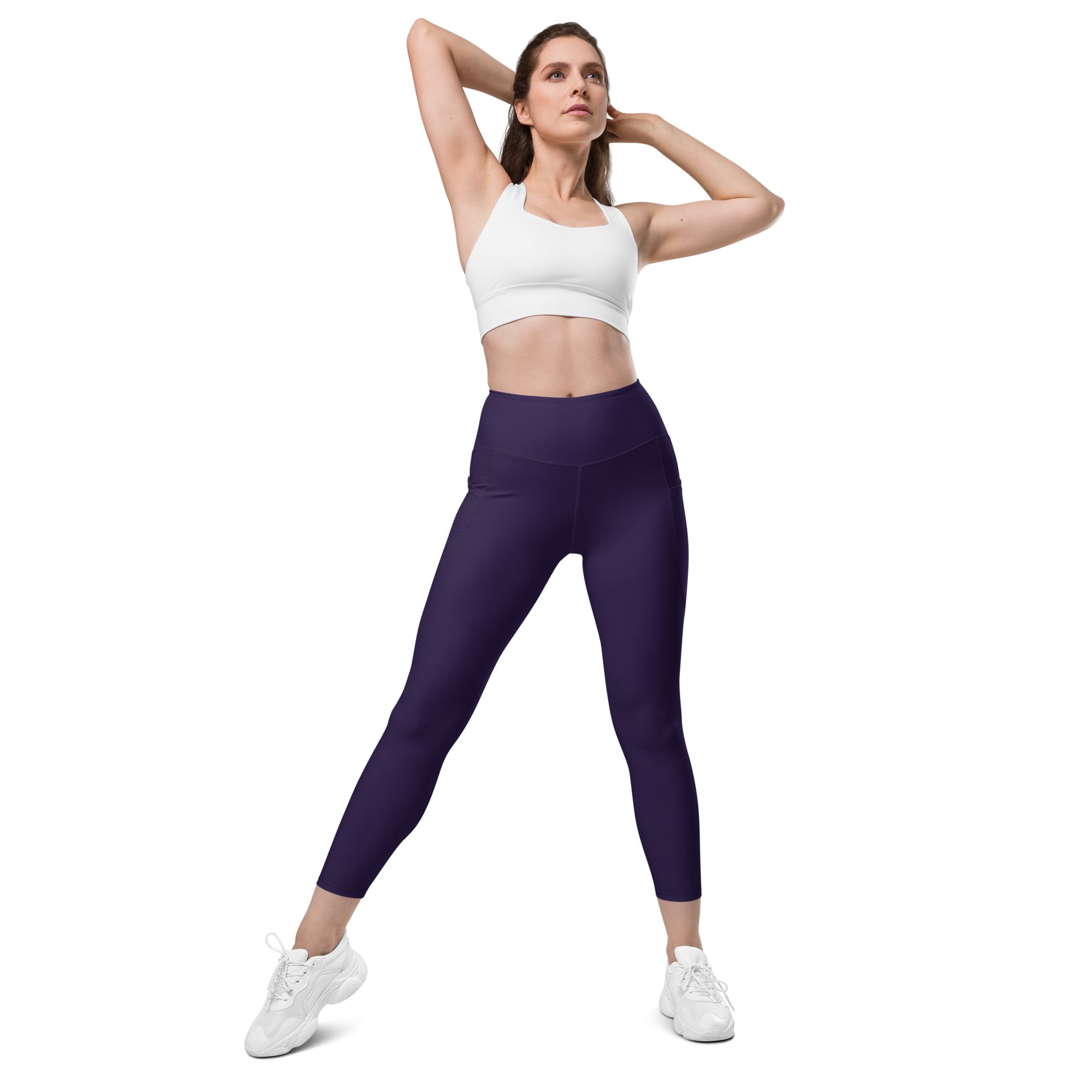 Women’s dark purple high-waisted yoga leggings with pockets featuring soft compression and a sleek form-fitting design