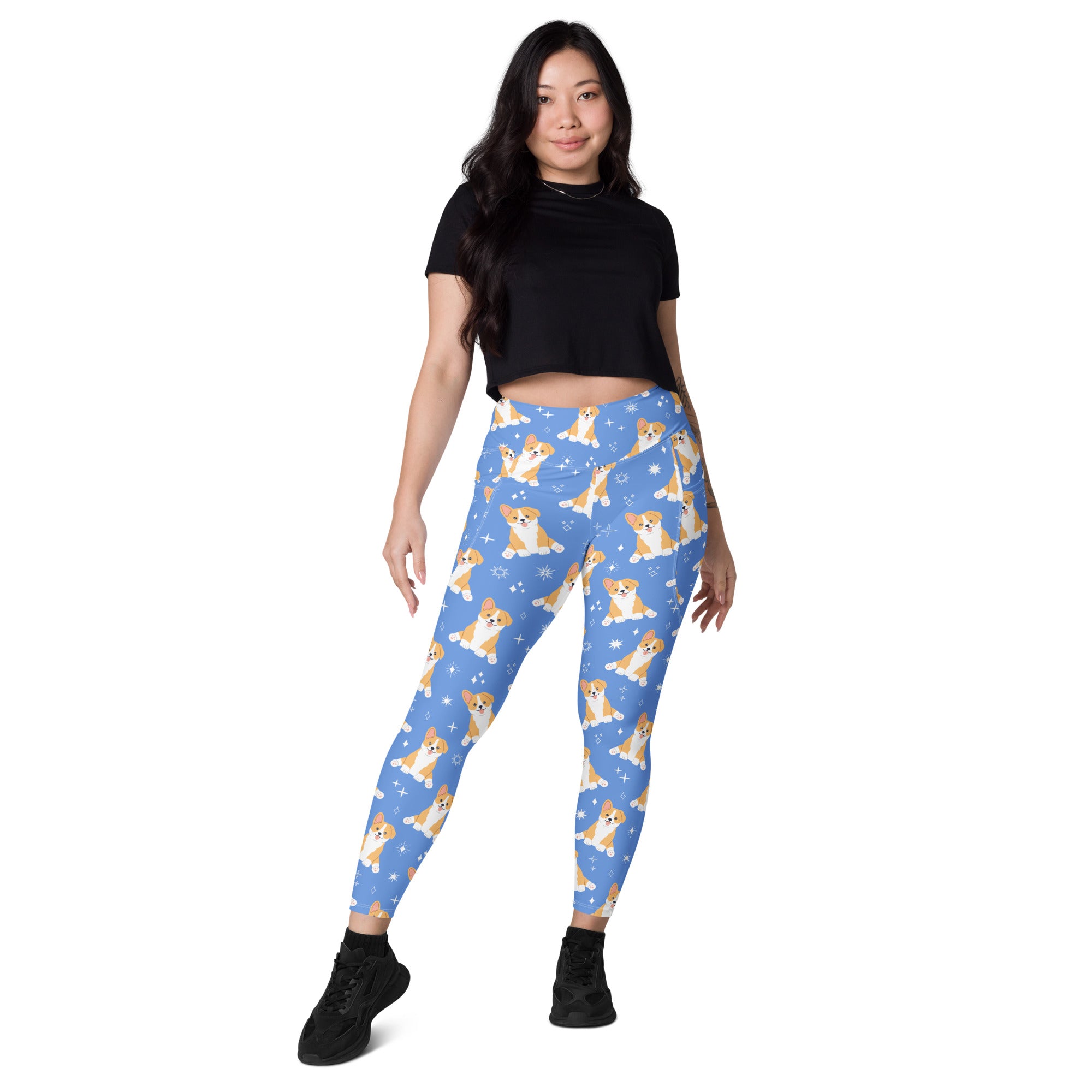 Women’s blue high-waisted yoga leggings with pockets feature soft compression and a playful tan and white corgi pattern with snowflakes