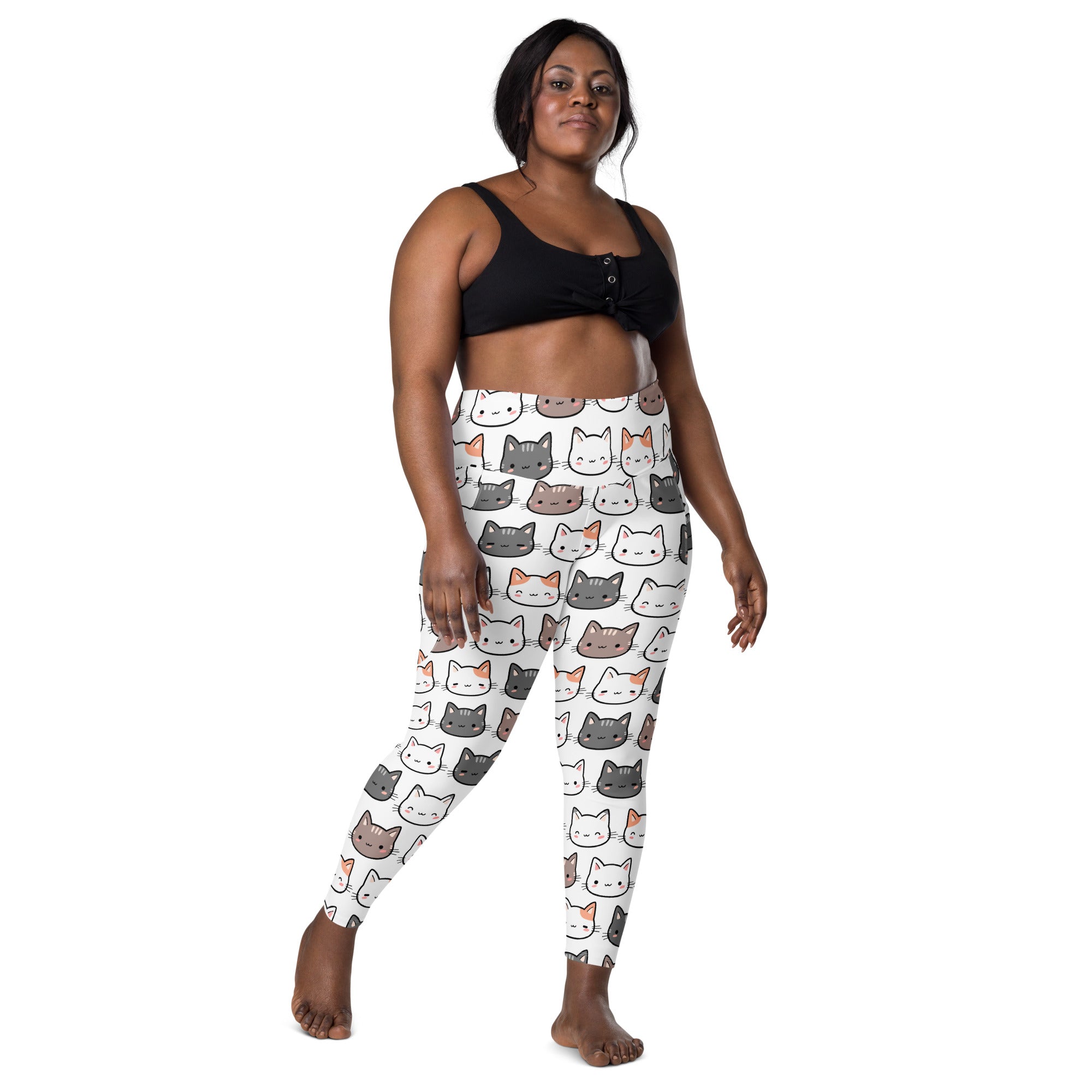 White high-waisted women’s yoga leggings with pockets featuring colorful cartoon cat faces and soft compression fabric