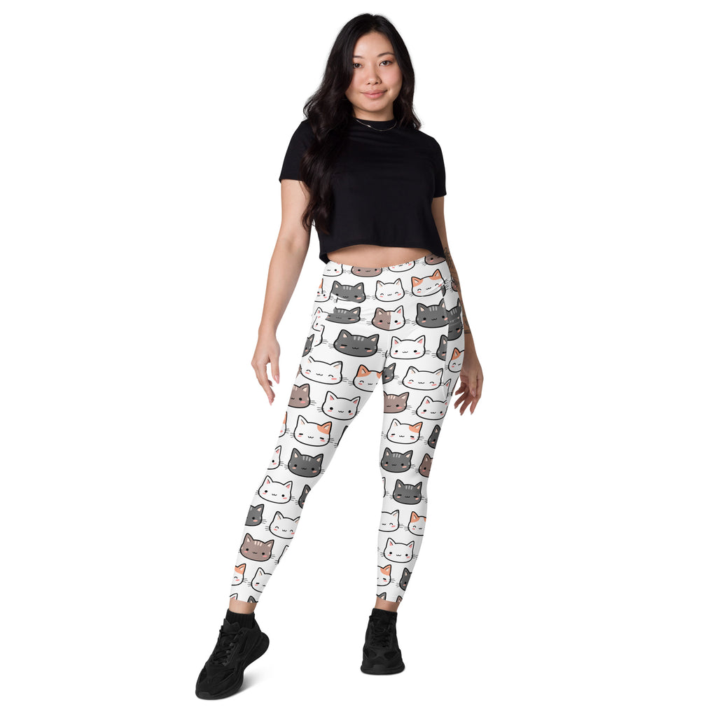 White women’s high-waisted yoga leggings with soft compression and colorful cartoon cat face pattern with pockets