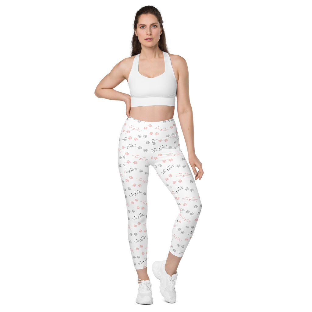 White high waisted cat paw print yoga leggings with pockets featuring a playful pink and gray paw print pattern