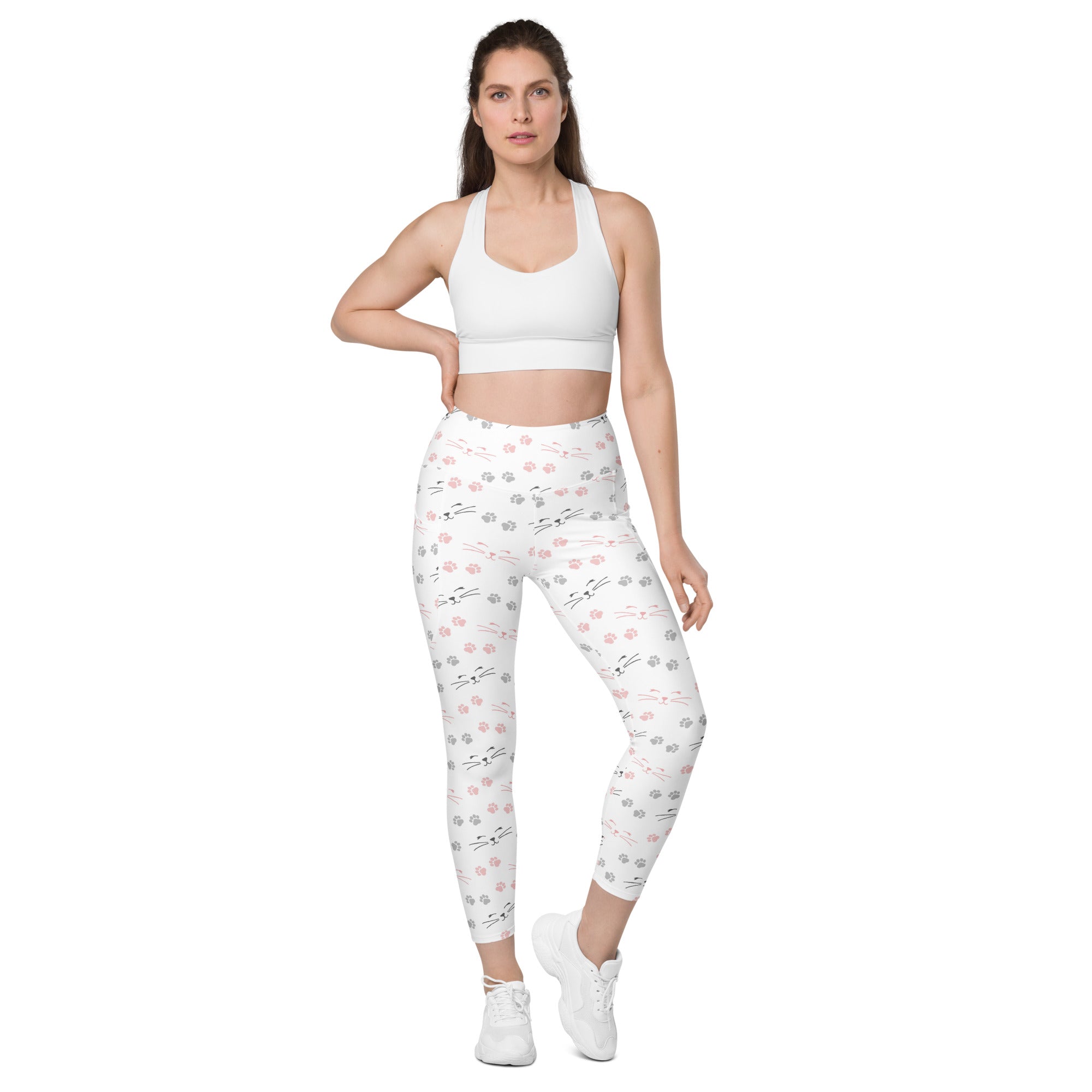 White high waisted cat paw print yoga leggings with pockets featuring a playful pink and gray paw print pattern