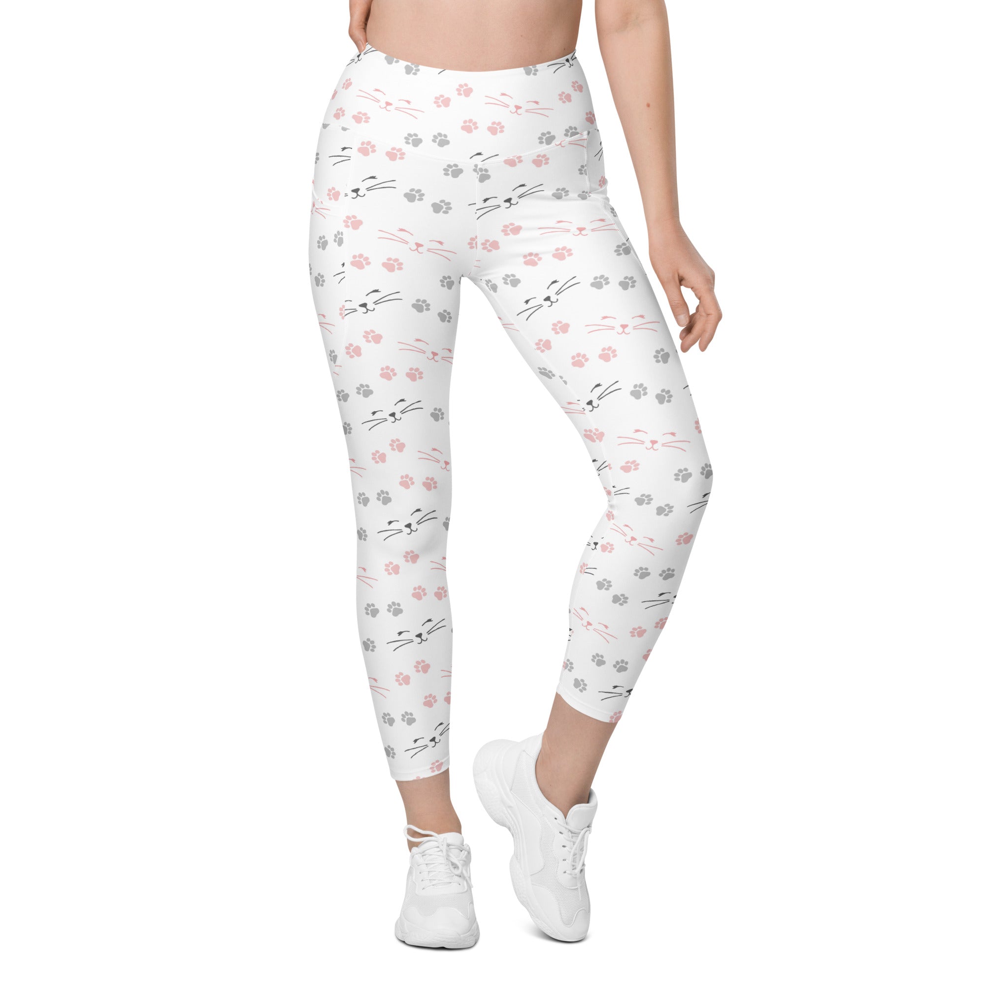 White women’s high-waisted cat paw print yoga leggings with pockets featuring pink and gray cat faces and paw prints