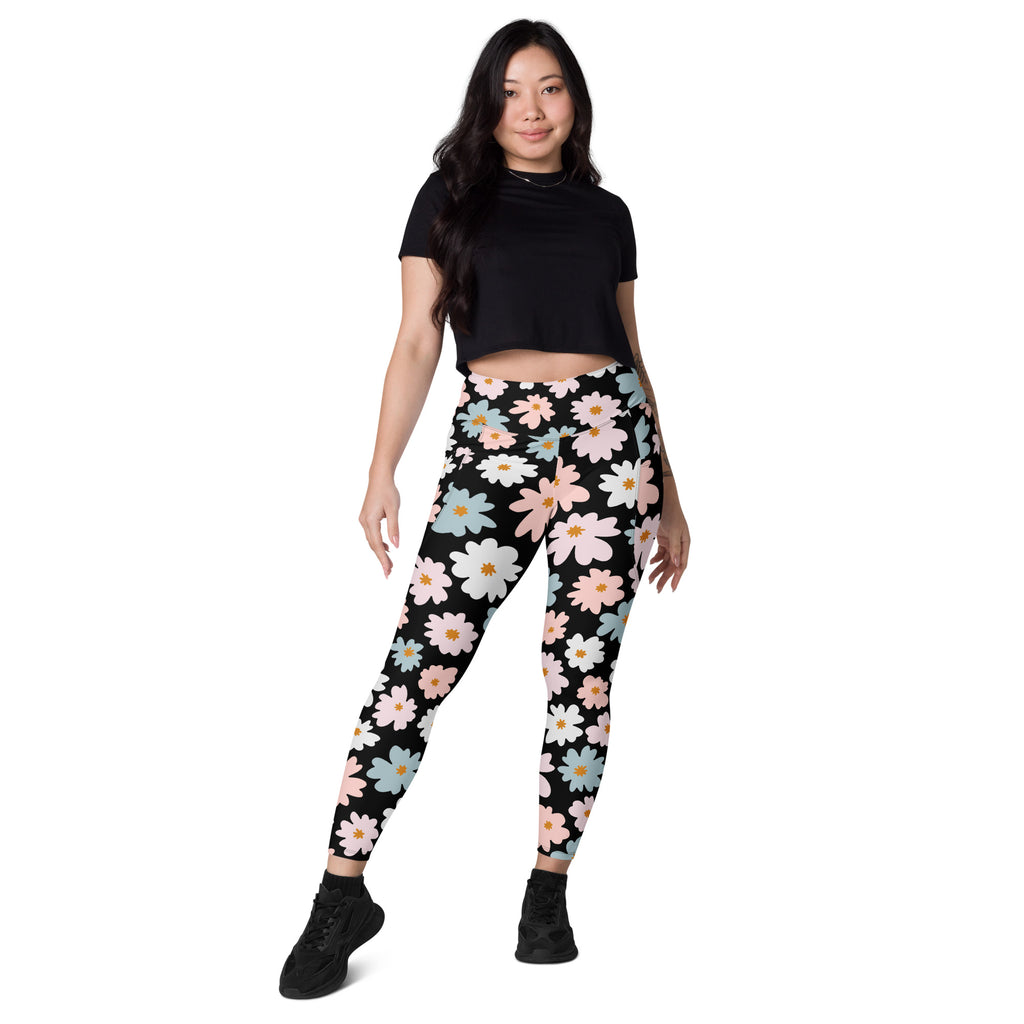 Women’s retro floral yoga leggings with pockets in black featuring pink white and light blue daisies and soft compression