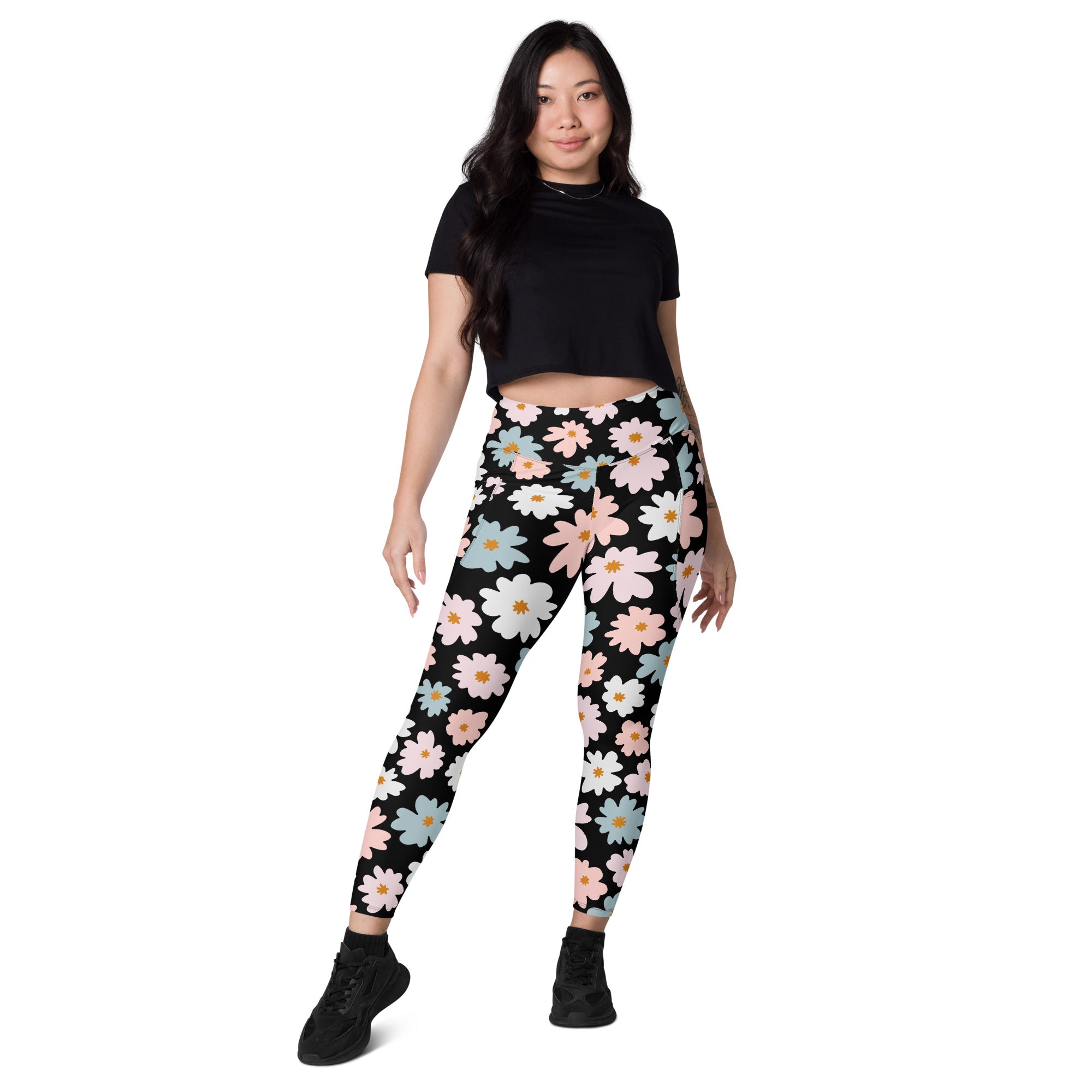 Women’s retro floral yoga leggings with pockets in black featuring pink white and light blue daisies and soft compression