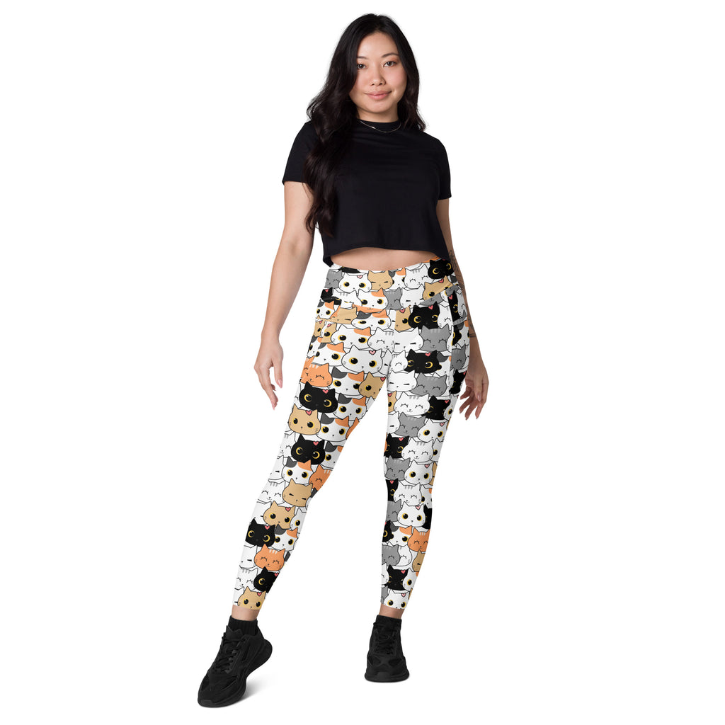White women’s high-waisted yoga leggings with soft compression and colorful cartoon cat faces and pockets