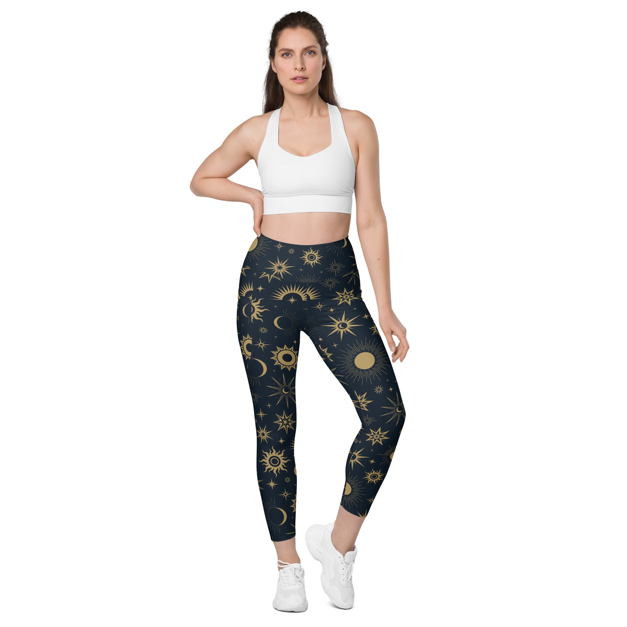 Dark blue women’s high-waisted yoga leggings with vibrant gold sun moon and star celestial pattern and pockets
