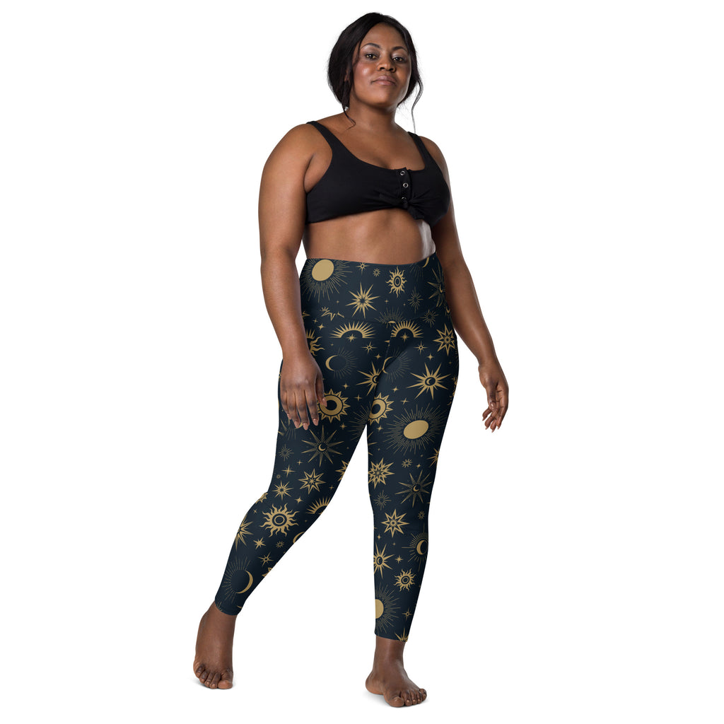 Dark blue high waisted womens yoga leggings with soft compression and vibrant gold sun moon star pattern and pockets