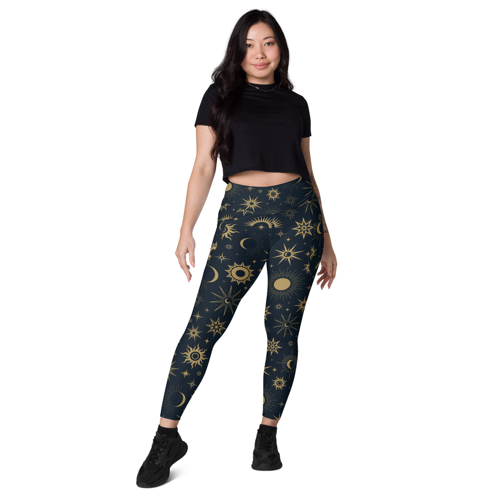 Dark blue women’s high-waisted yoga leggings with vibrant gold celestial sun moon and star pattern and pockets