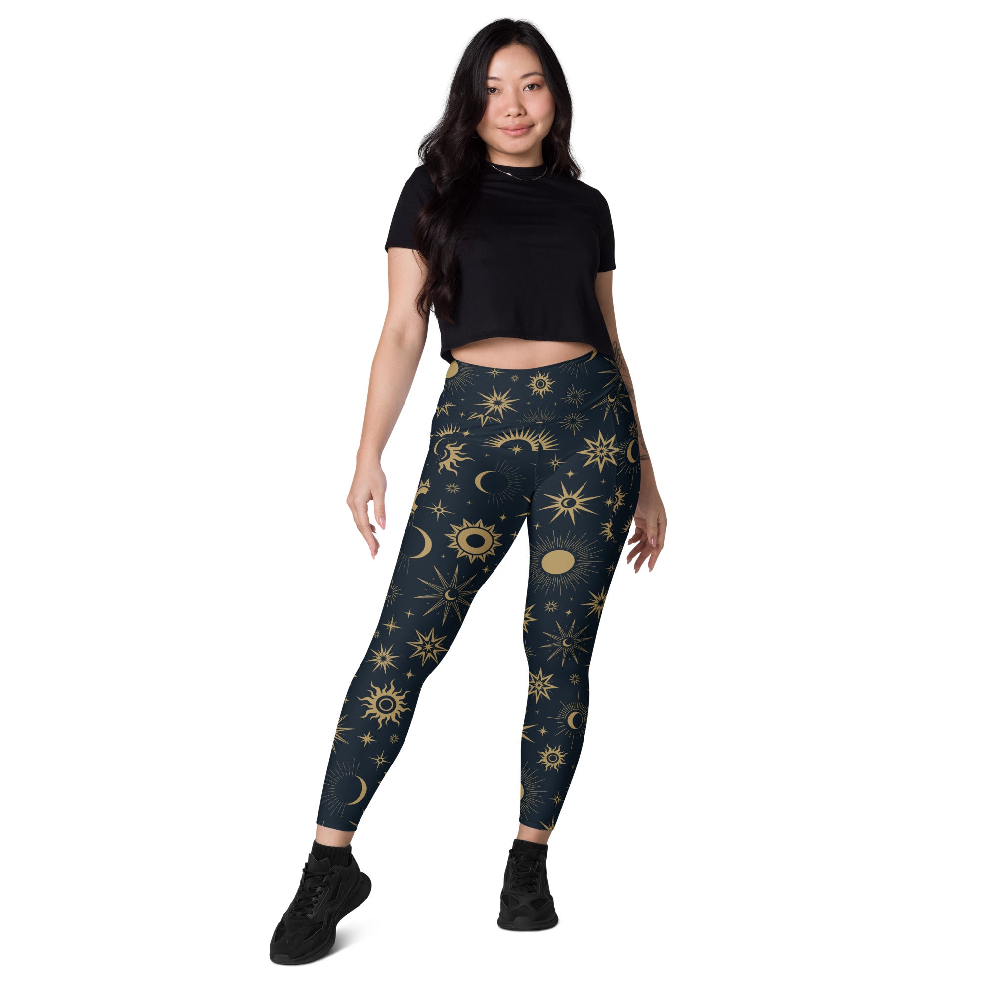 Dark blue women’s high-waisted yoga leggings with vibrant gold celestial sun moon and star pattern and pockets