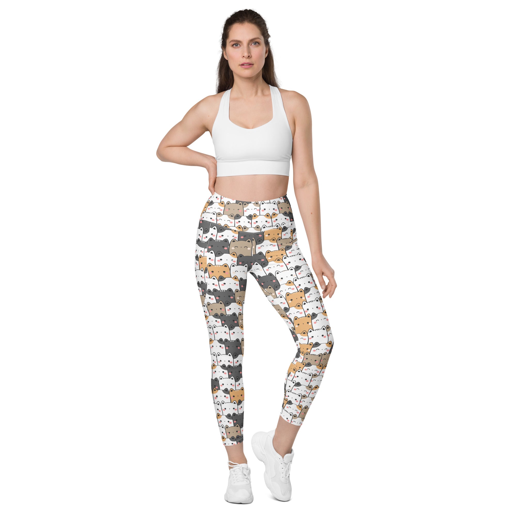 Women’s kawaii cat yoga leggings with pockets featuring white and beige soft compression fabric and playful cartoon cats