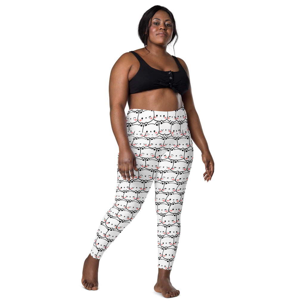 White high waisted yoga leggings with soft compression and cartoon cat face pattern with black outlines and pink accents