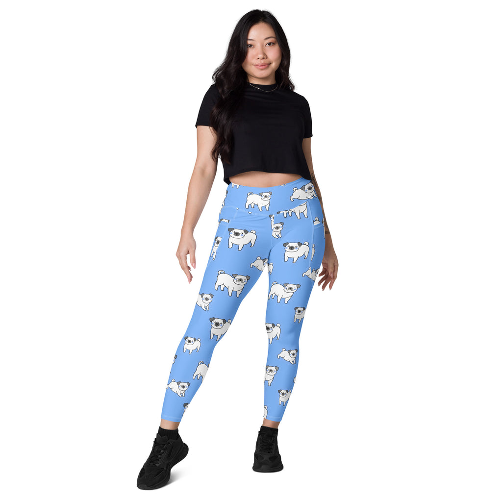 Light blue women’s high-waisted yoga leggings with pockets featuring white pug pattern and soft compression fabric