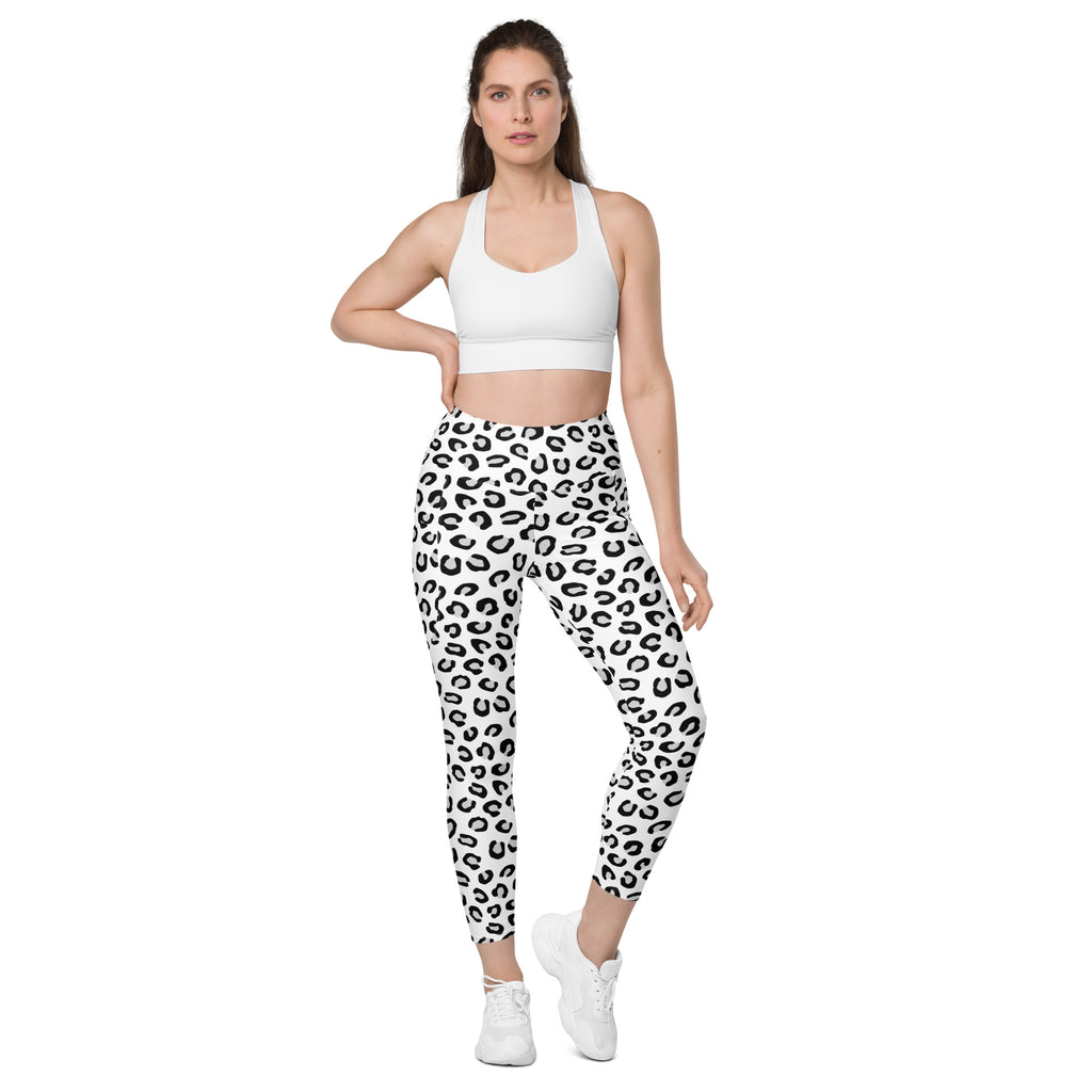 Women’s high-waisted white leggings with bold black leopard print and pockets made of soft compression fabric for yoga