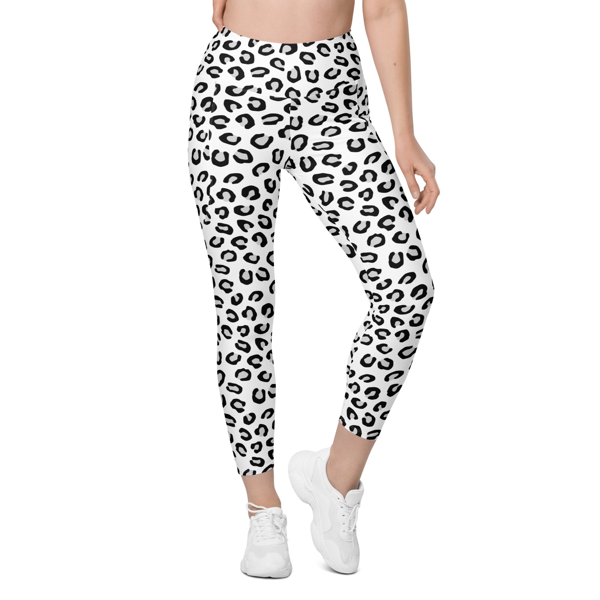 Women’s high-waisted white leopard yoga leggings with bold black print soft compression and pockets for activewear