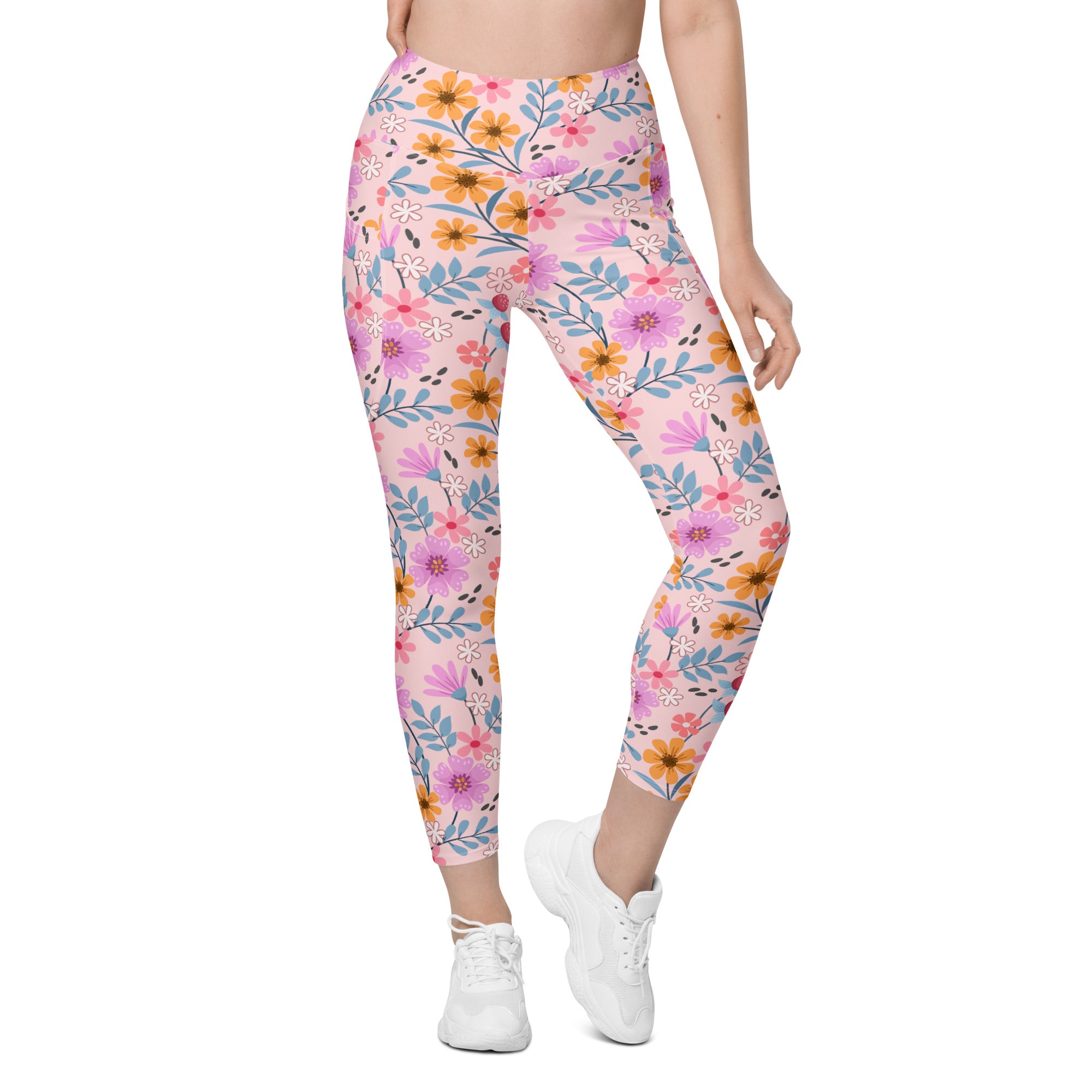 Women’s pink floral yoga leggings with pockets featuring a vibrant purple orange and blue flower pattern on soft fabric