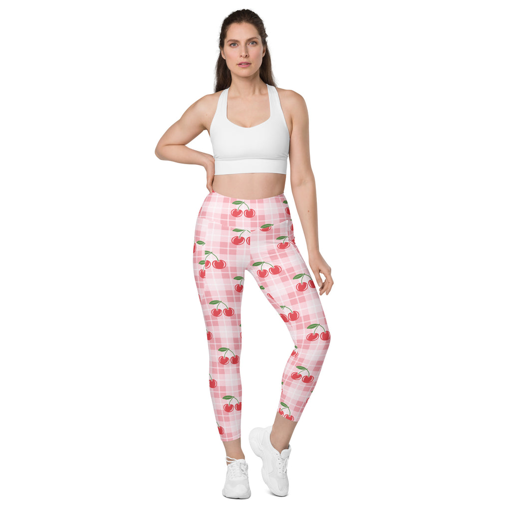 Women’s high-waisted pink cherry-patterned yoga leggings with pockets and subtle plaid background soft compression