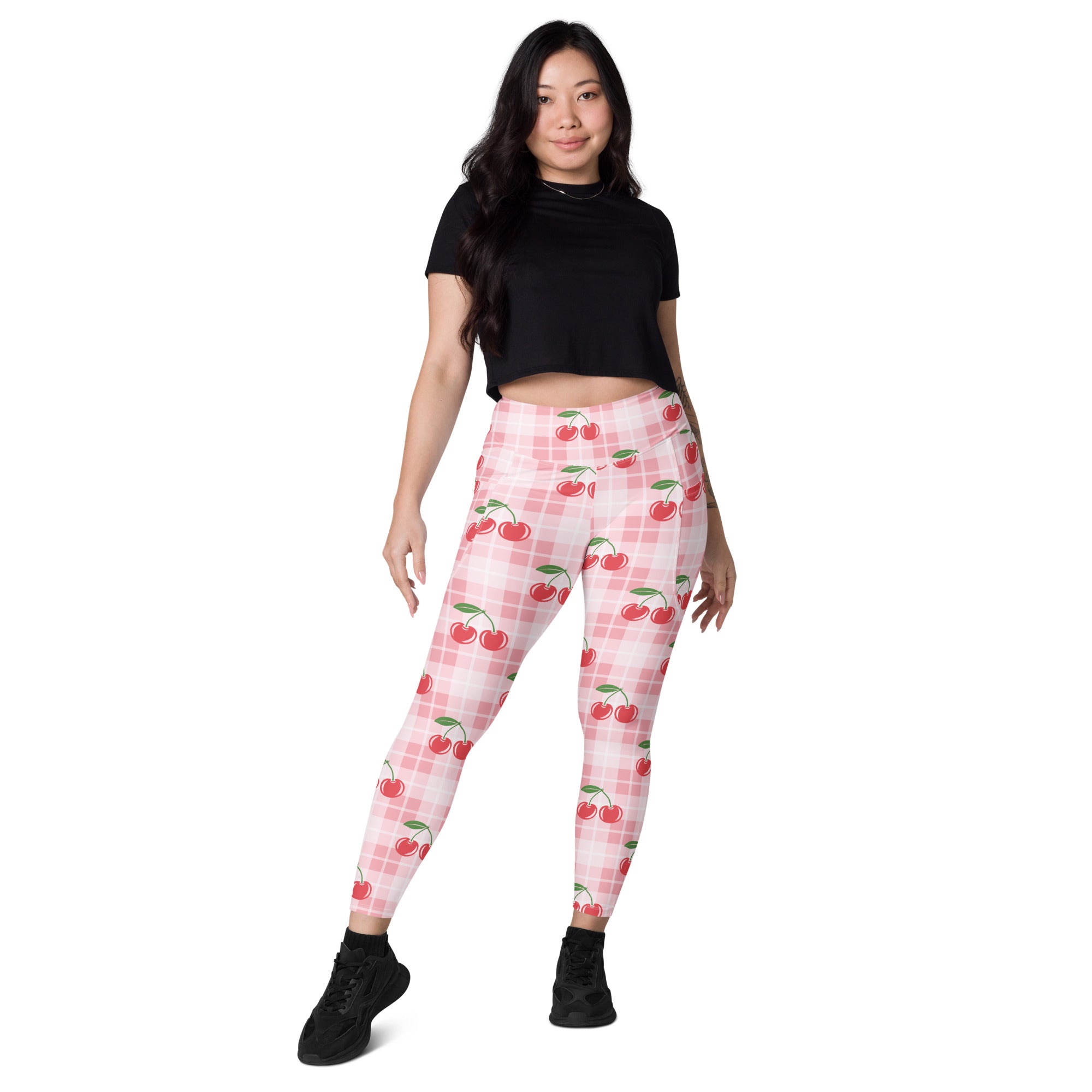 Women’s pink cherry gingham high-waisted yoga leggings with pockets and soft compression active pants on checkered background