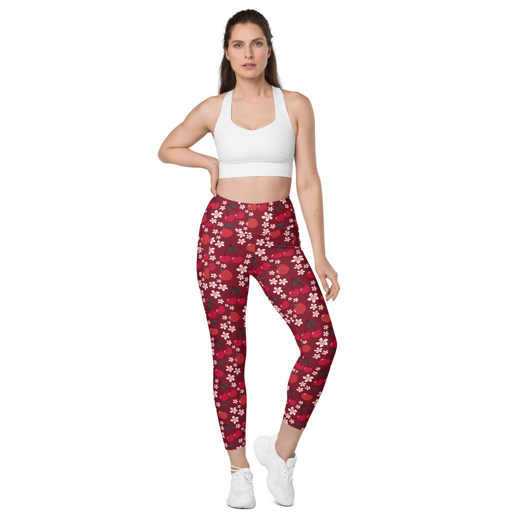 Women’s high-waisted red cherry blossom yoga leggings with white and pink floral pattern and soft compression pockets