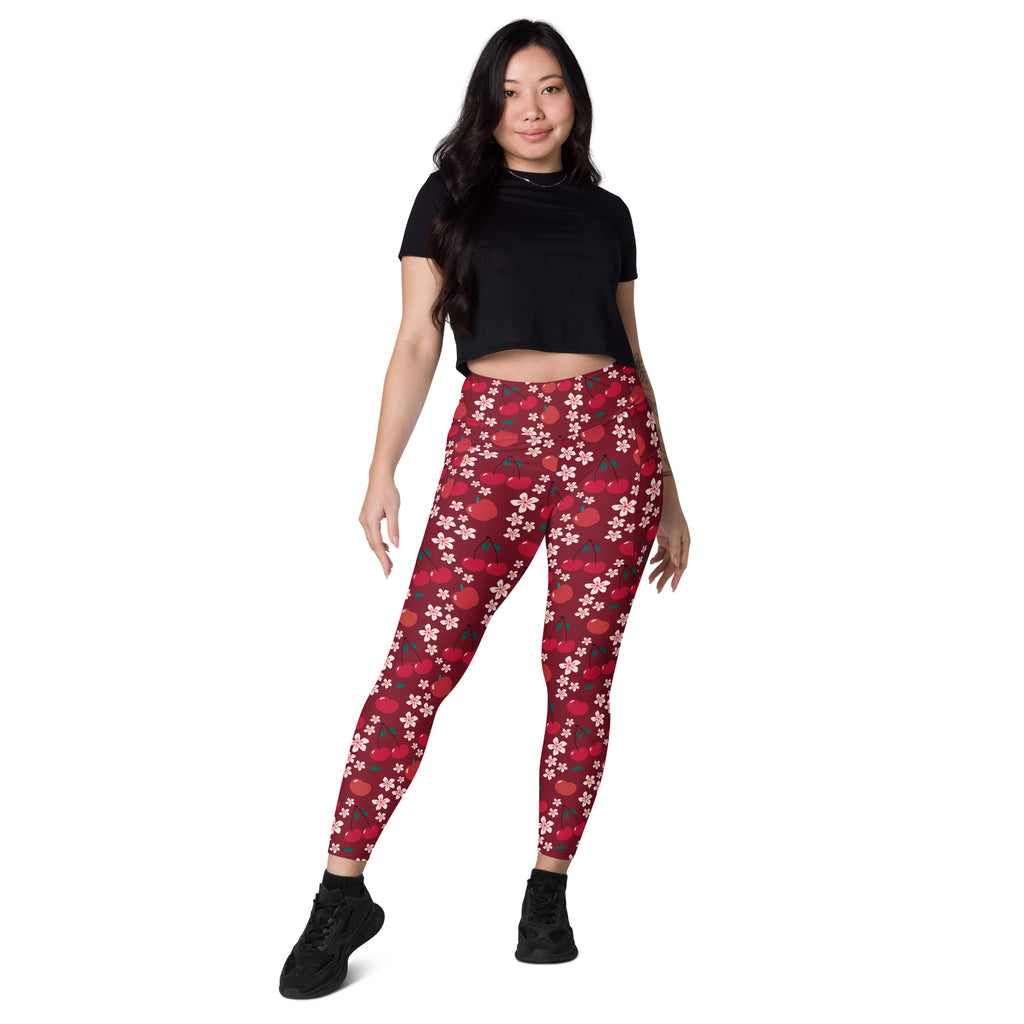 Women’s high-waisted red cherry blossom yoga leggings with pockets featuring white and dark red floral patterns
