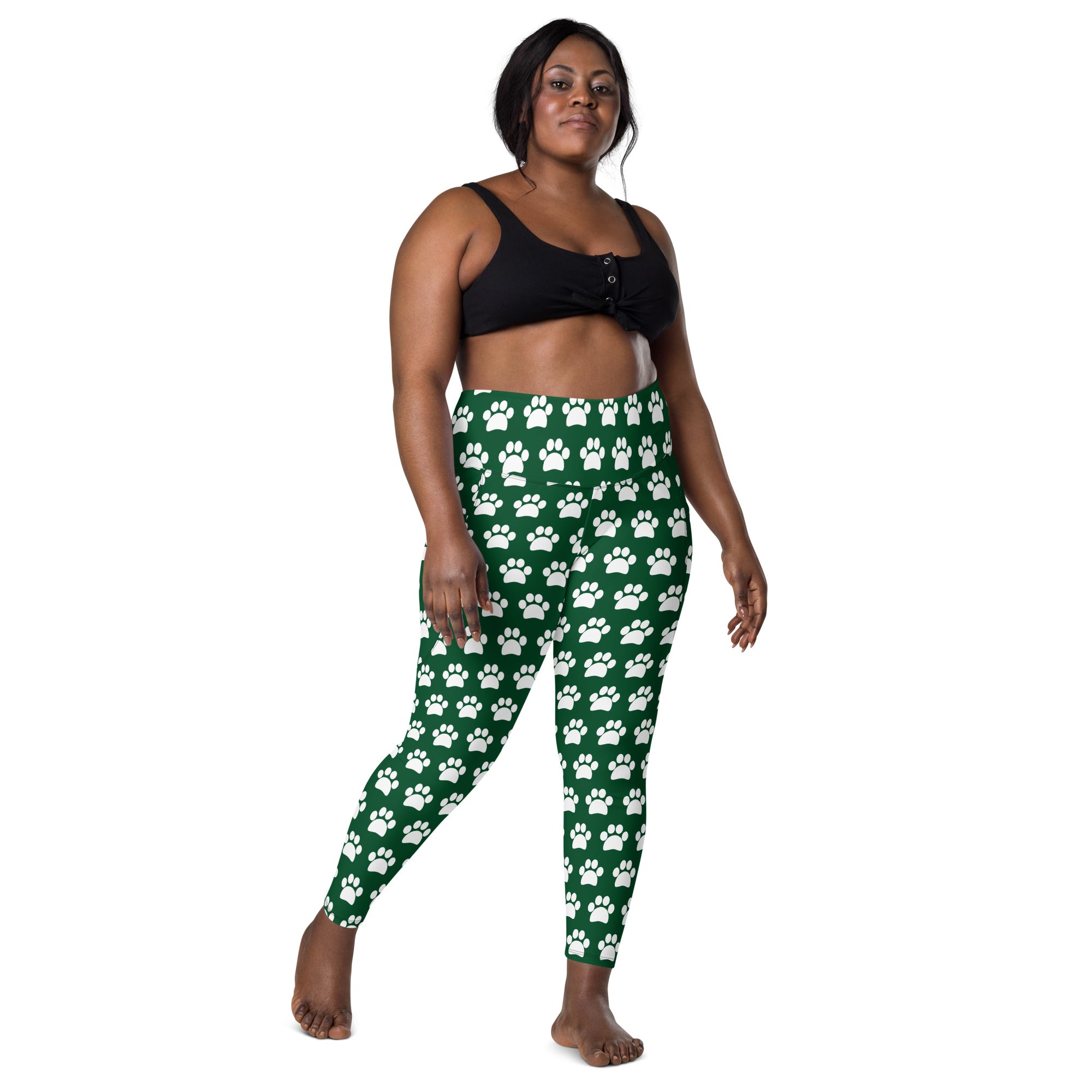 Women’s green high-waisted yoga leggings with white paw print pattern soft compression and pockets