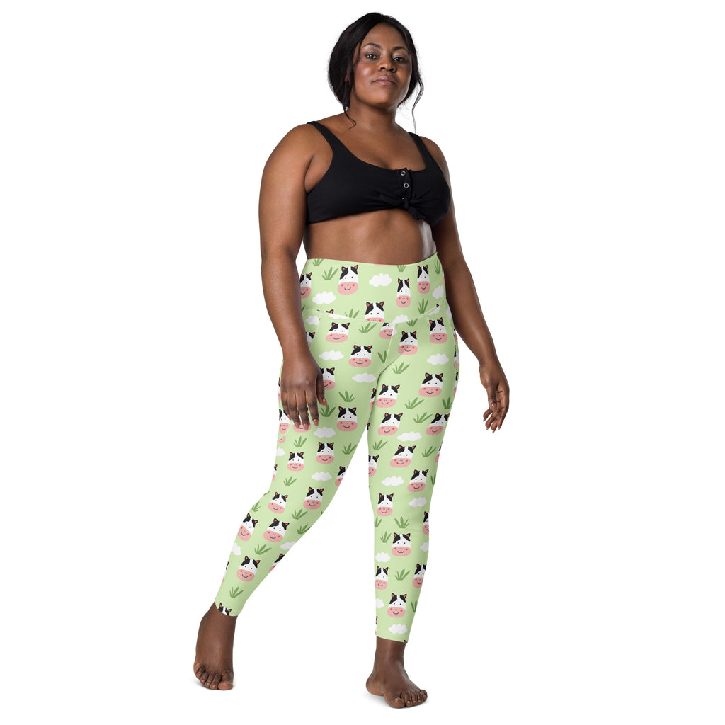 Women’s light green plus-size high-waisted yoga leggings with pockets featuring cute cartoon cow face pattern