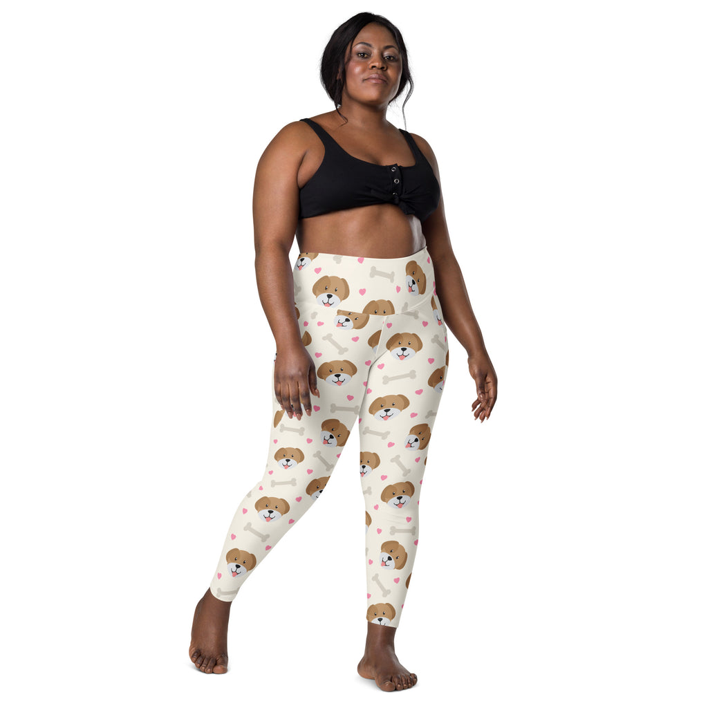 Cream-colored women’s cute dog yoga leggings with pockets featuring brown puppy faces white bones and pink hearts pattern