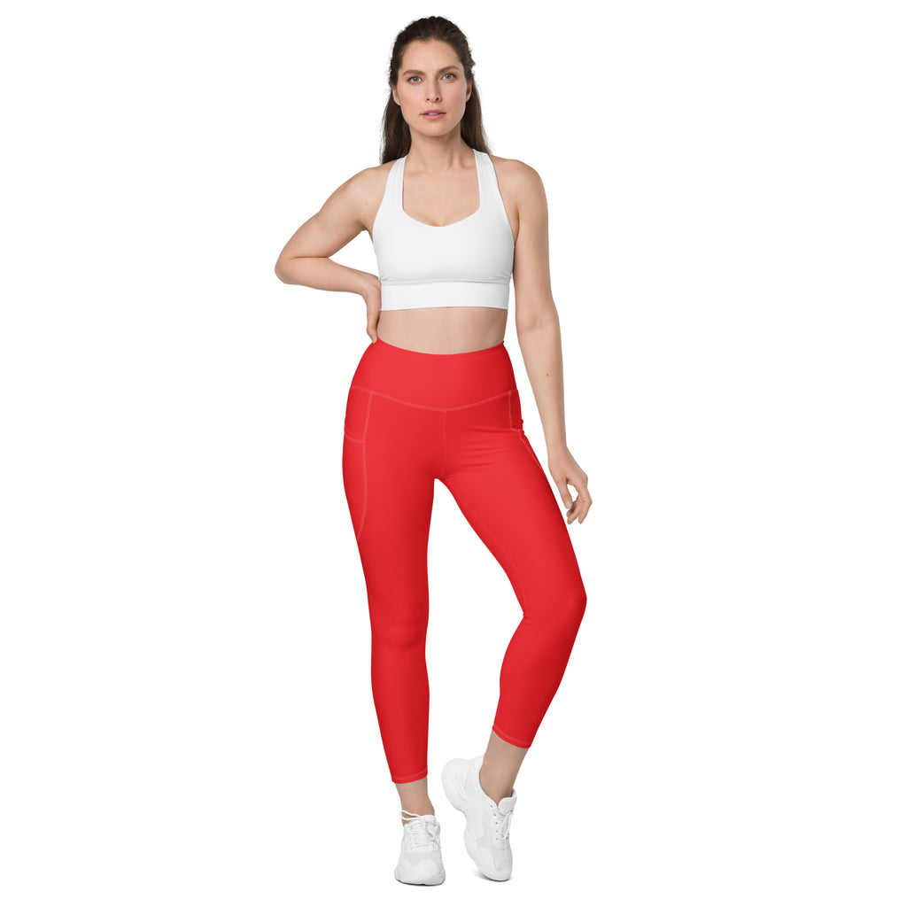 Women’s red high-waisted yoga leggings with pockets featuring soft compression and a sleek, form-fitting design