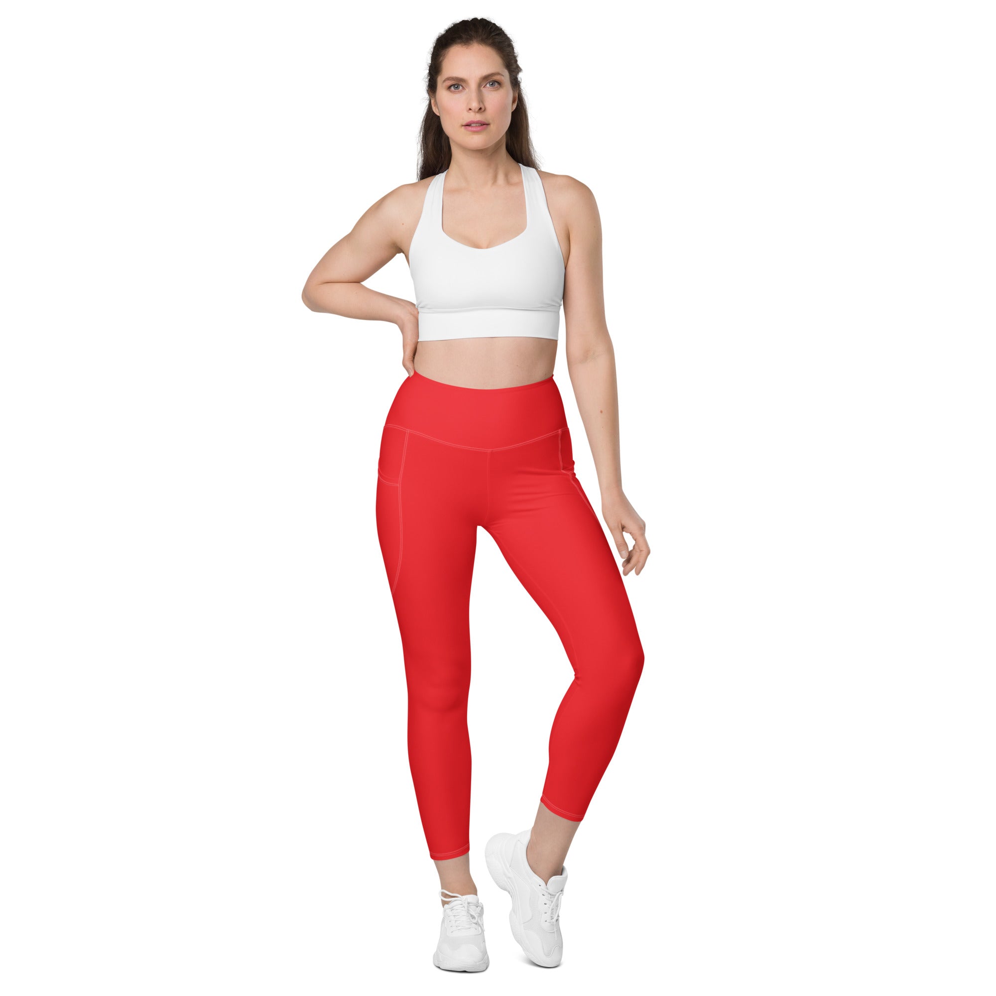 Women’s red high-waisted yoga leggings with pockets featuring soft compression and a sleek, form-fitting design