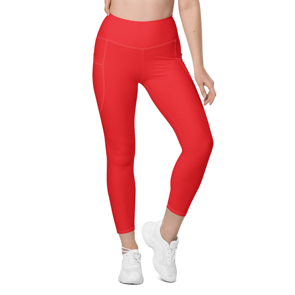 Women’s red high-waisted yoga leggings with smooth stretchy fabric and side pockets for soft compression activewear