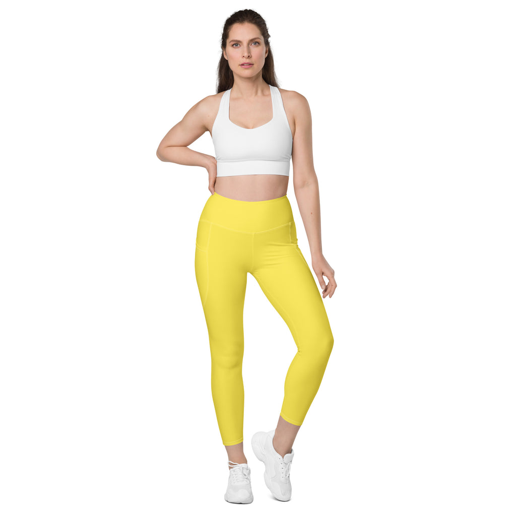 Women’s yellow high-waisted yoga leggings with pockets made of smooth stretchy fabric for soft compression activewear