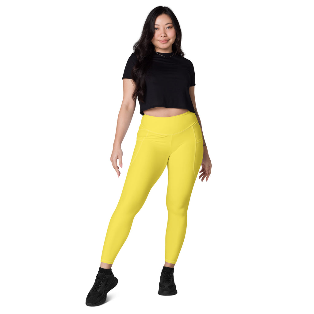Women’s yellow high-waisted yoga leggings with soft compression fabric and side pockets for activewear use
