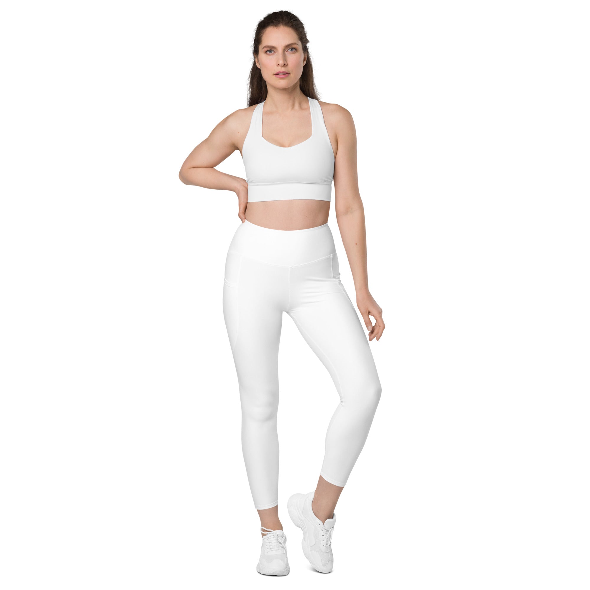 Women’s white seamless high-waisted yoga leggings with subtle side pockets and soft compression fabric