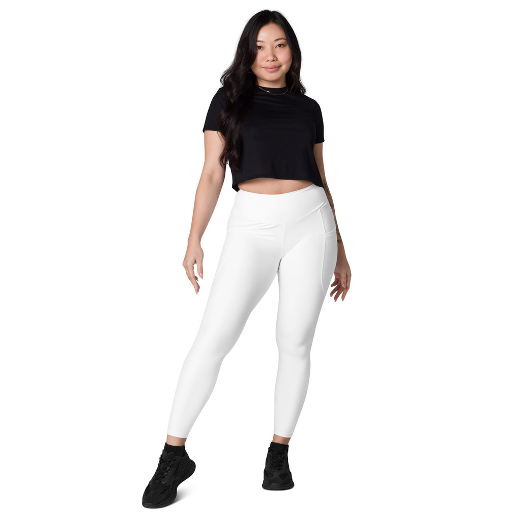 Women’s white high waisted yoga leggings with soft compression material and subtle side pockets for activewear