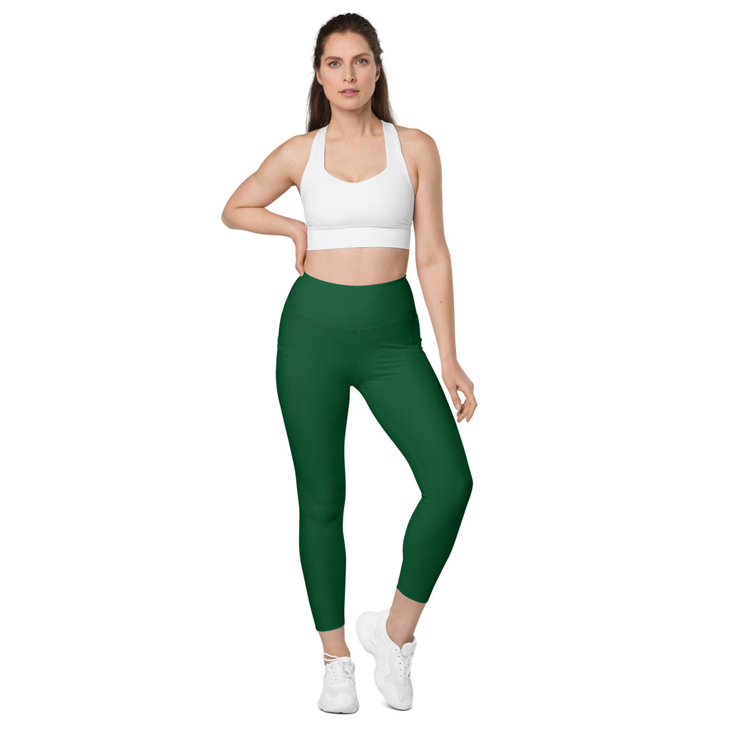 Women’s dark green high-waisted yoga leggings with pockets made of smooth stretchy fabric and cropped hemline
