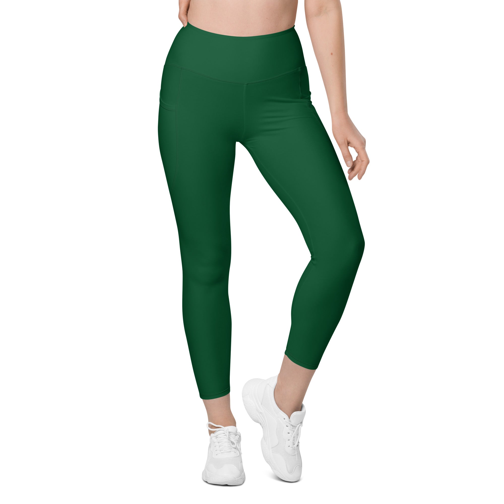 Women’s dark green high-waisted yoga leggings with pockets made from smooth stretchy soft compression fabric